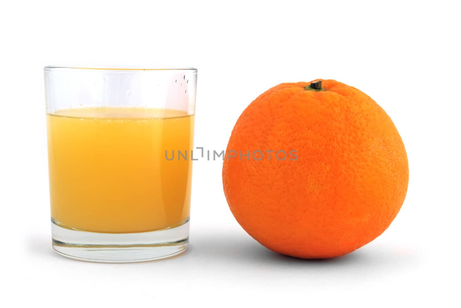 orange and a glass of juice on a white background