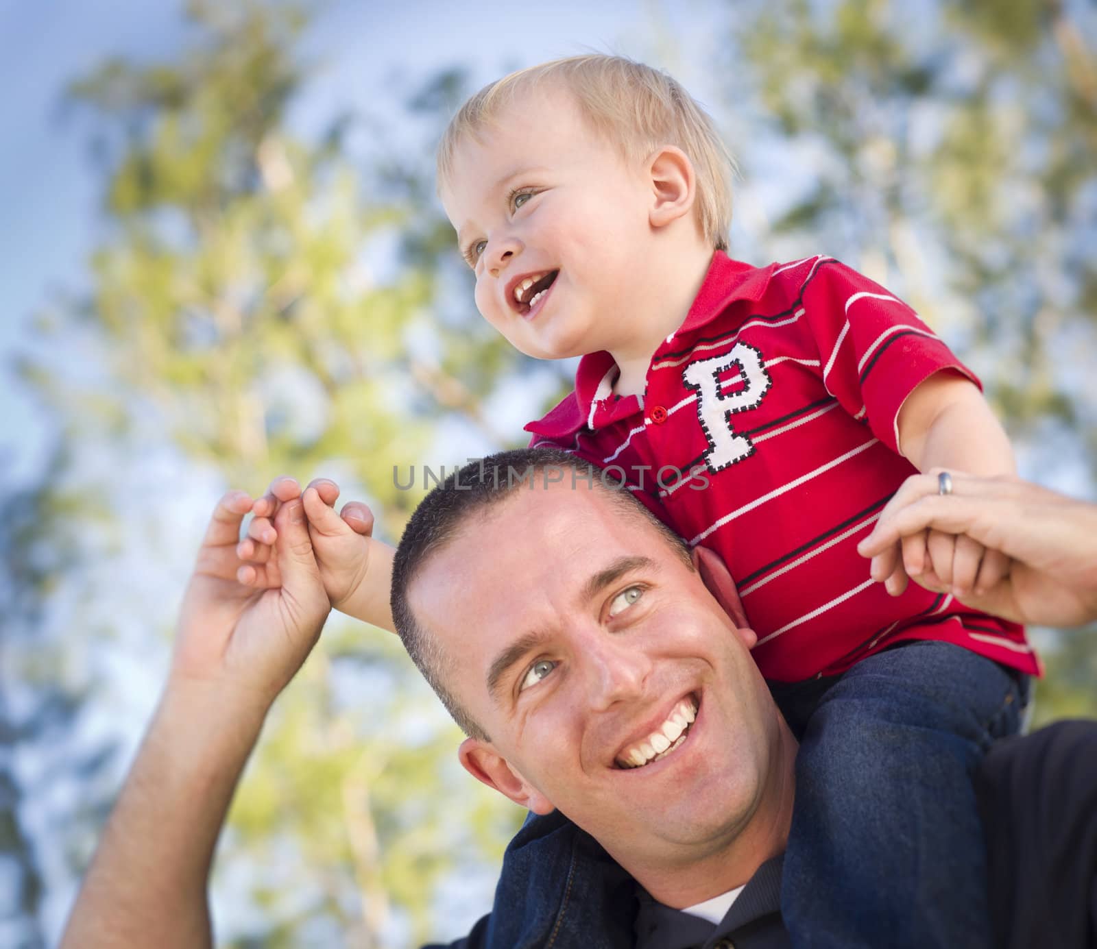 Young Laughing Father and Child  Having Piggy Back Fun.