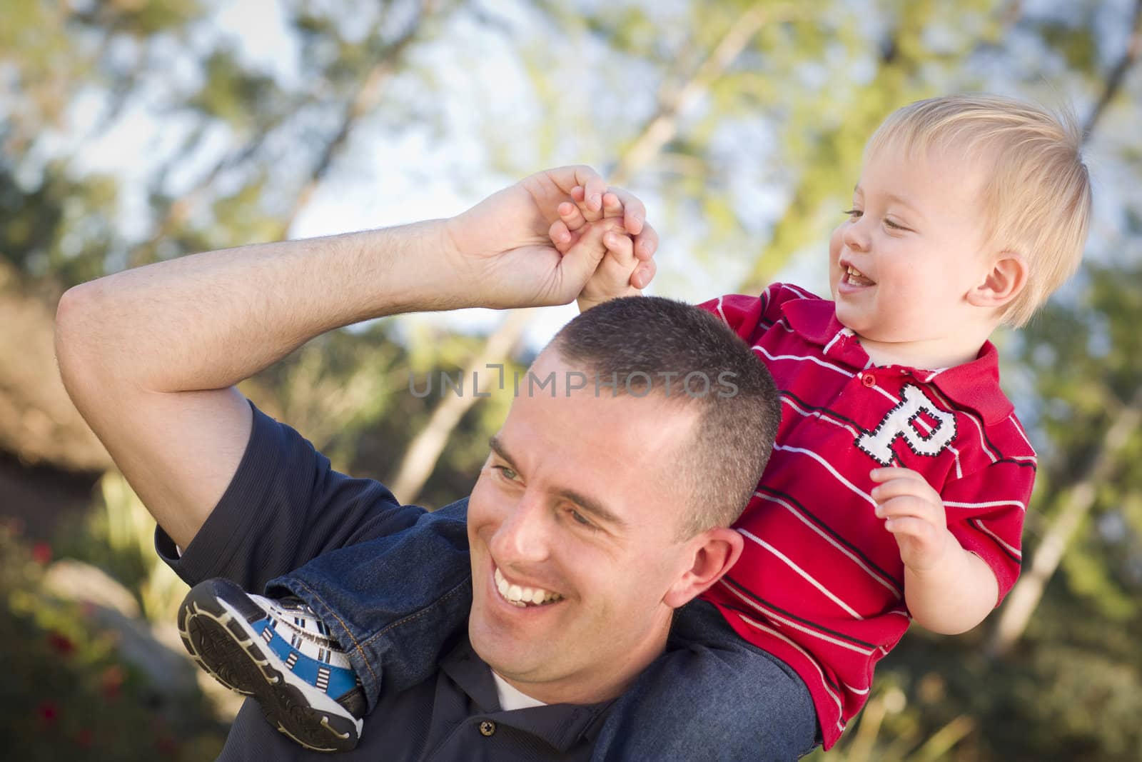 Young Laughing Father and Child  Having Piggy Back Fun.