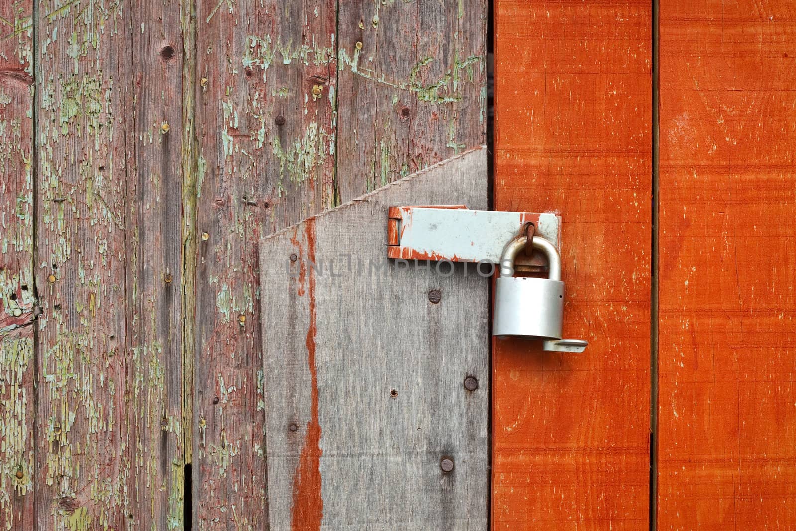 Locked wooden barn door with detailed texture and colour contrast