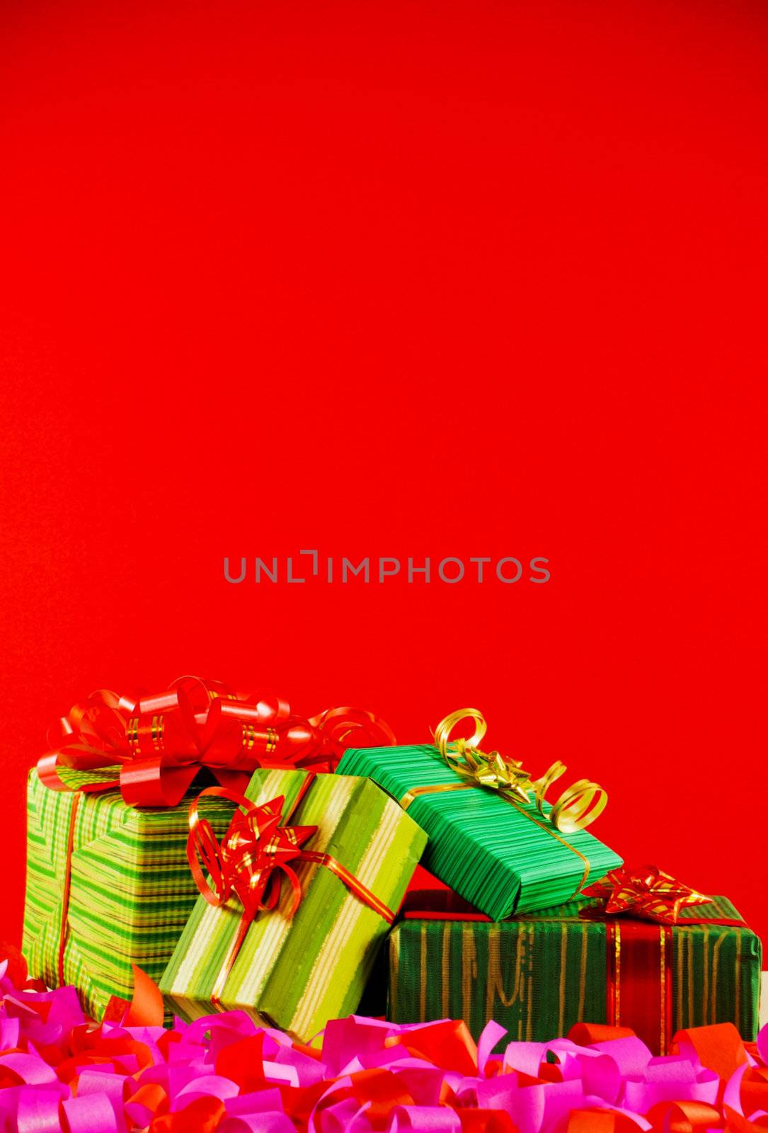 Wrapped boxes with presents against red background