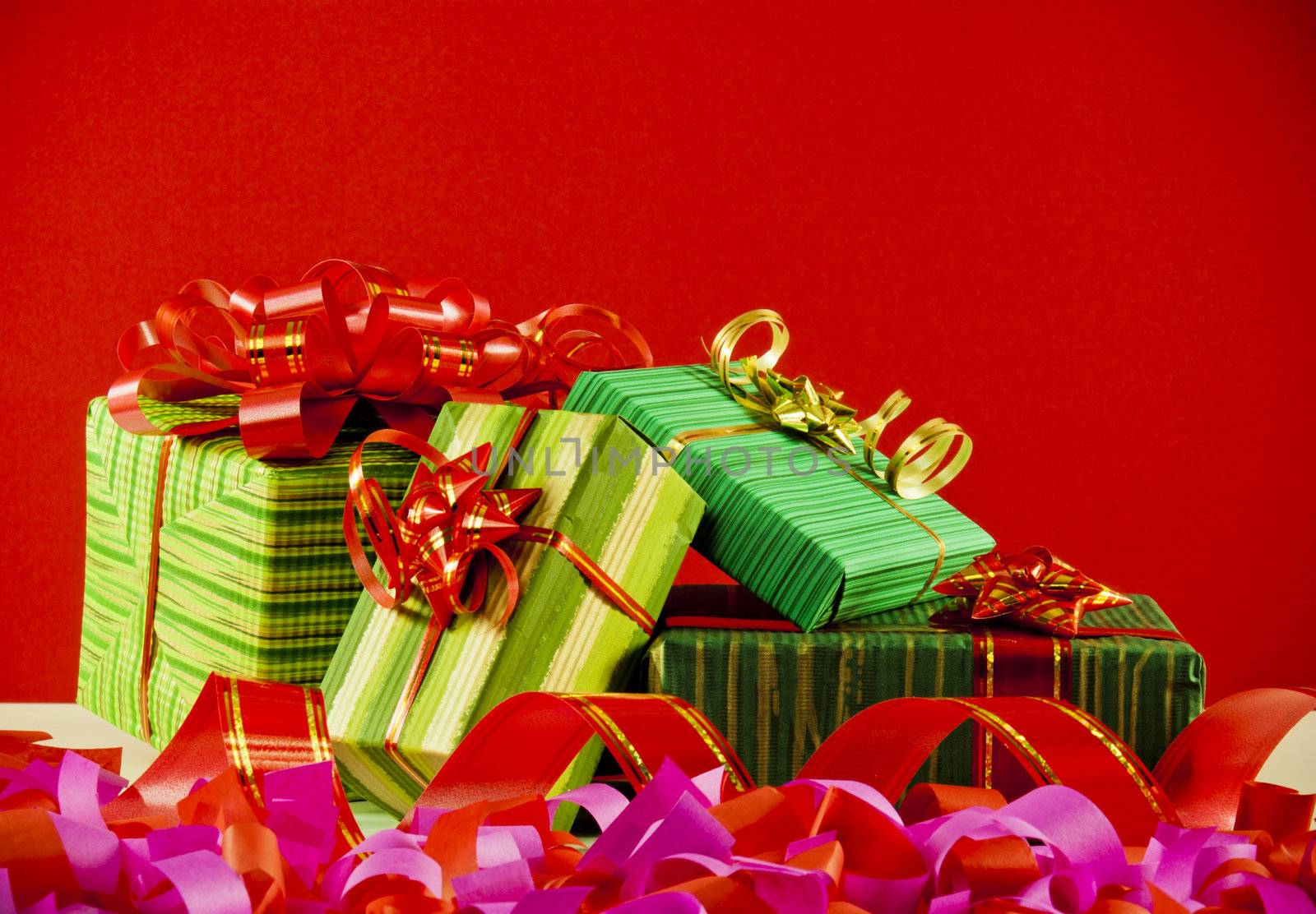 Wrapped boxes with presents against red background