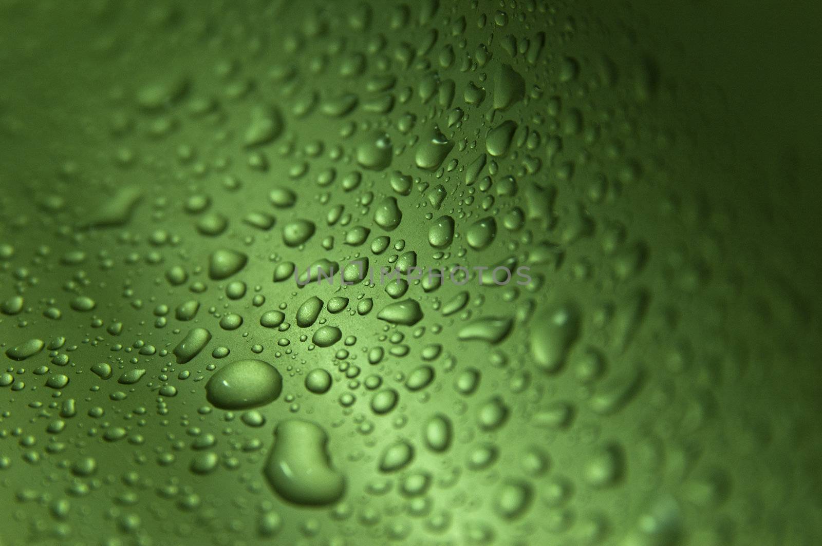 Zoomed drops on green wavy background making texture