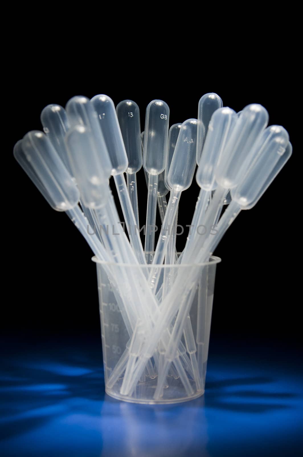 Zoomed pack of pipettes standing in measure glass