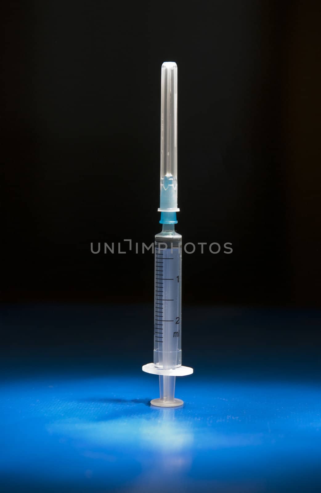 Empty and isolated medical syringe standing head up