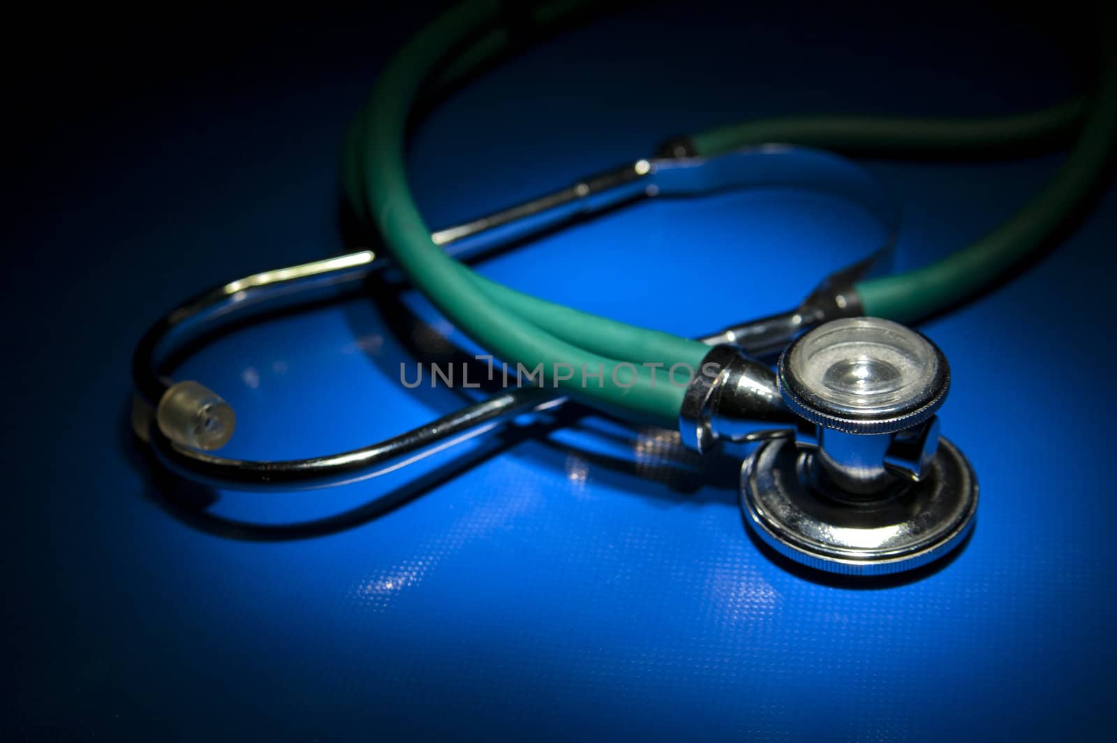 Isolated green stethoscope waiting for patients to inspect