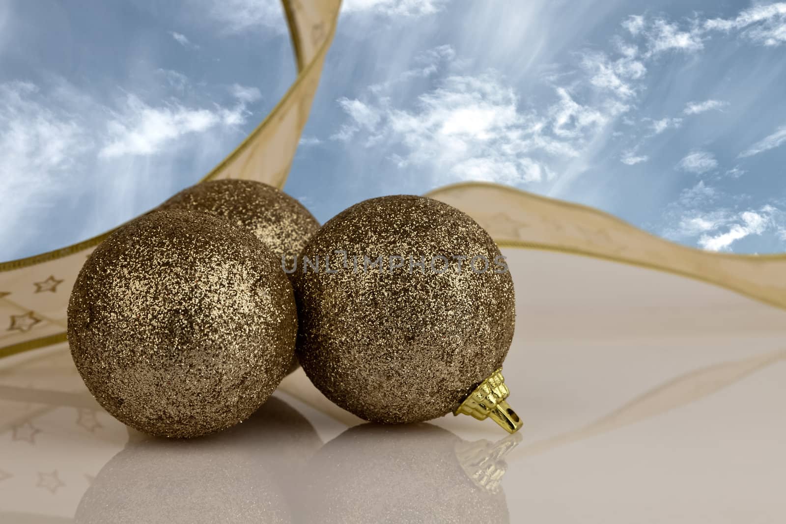 Gold Christmas Baubles with gold ribbon.