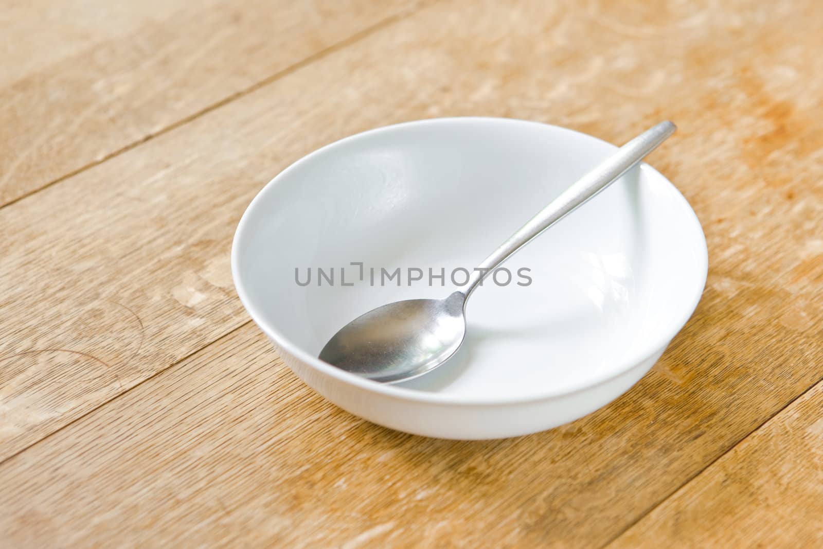 Breakfast bowl and spoon on a rustic wooden table top