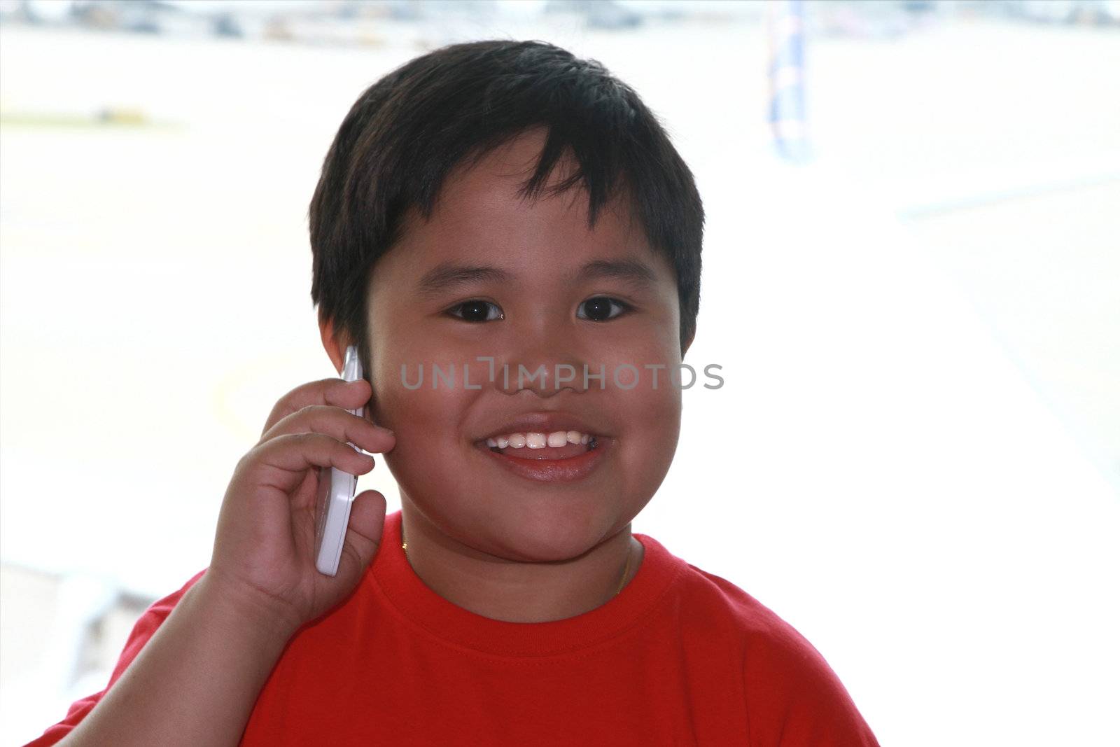 Cclose up portrait boy with cell phone .