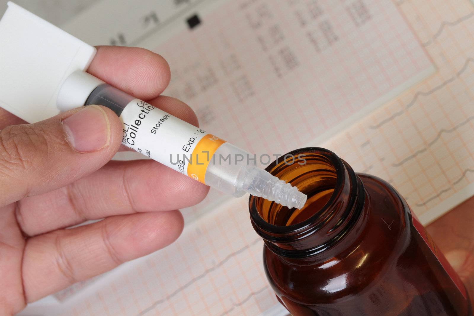 medicine bottle and spatula filler with medical result as background.
