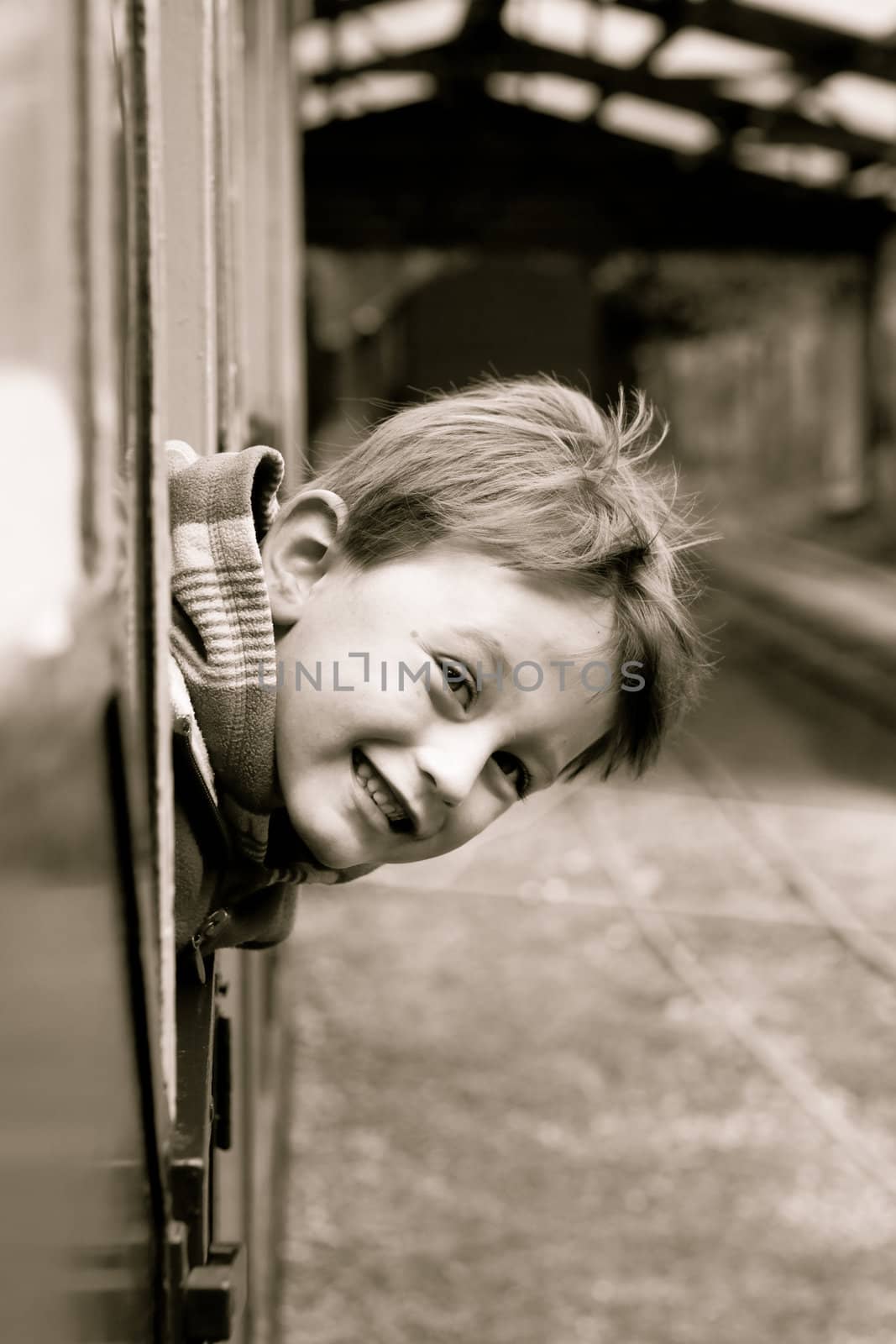 Little boy leaning out of a train window by trgowanlock