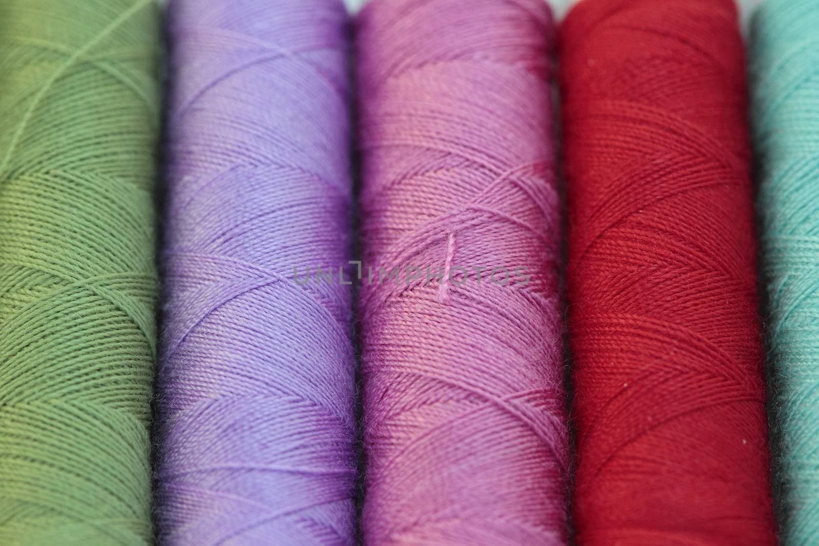 spools of many colors of thread  by sacatani