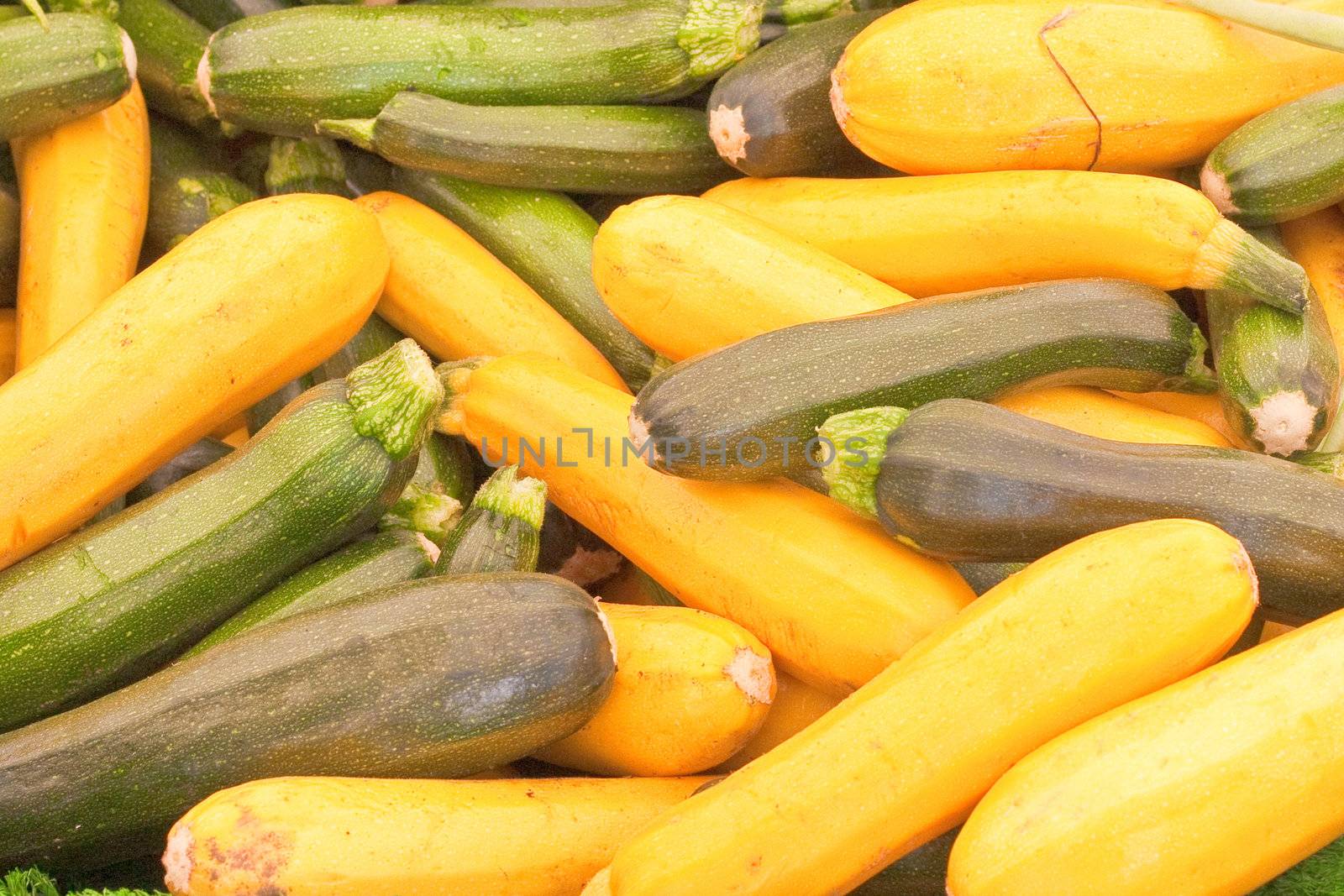 Mixed yellow and green courgettes as a background image