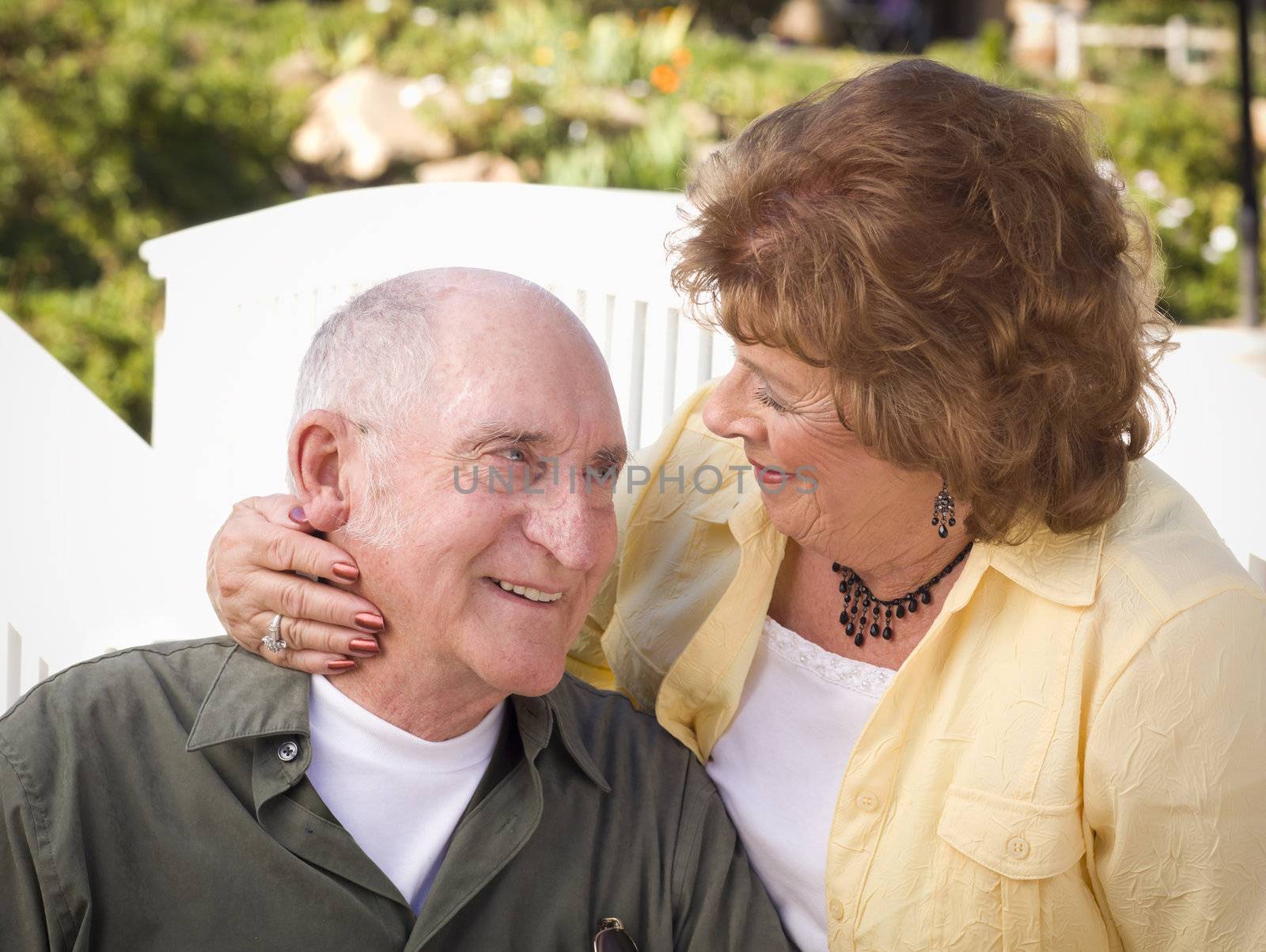 Happy Senior Couple Kissing in the Park.