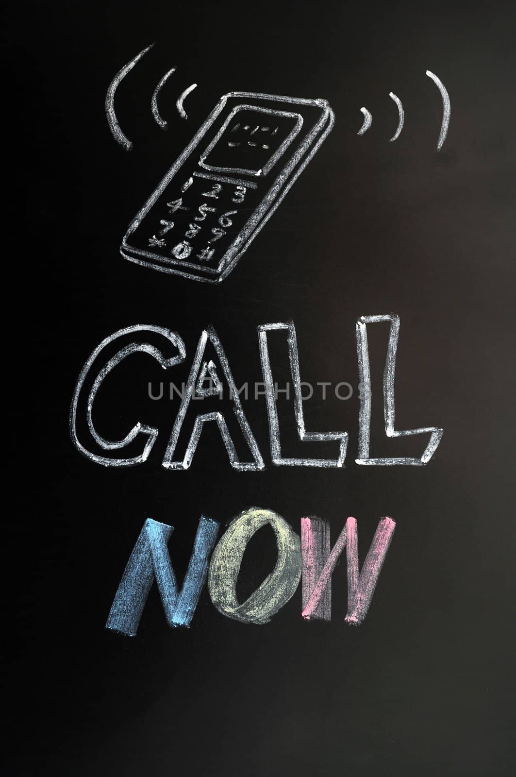 Call now - text written in chalk on a blackboard