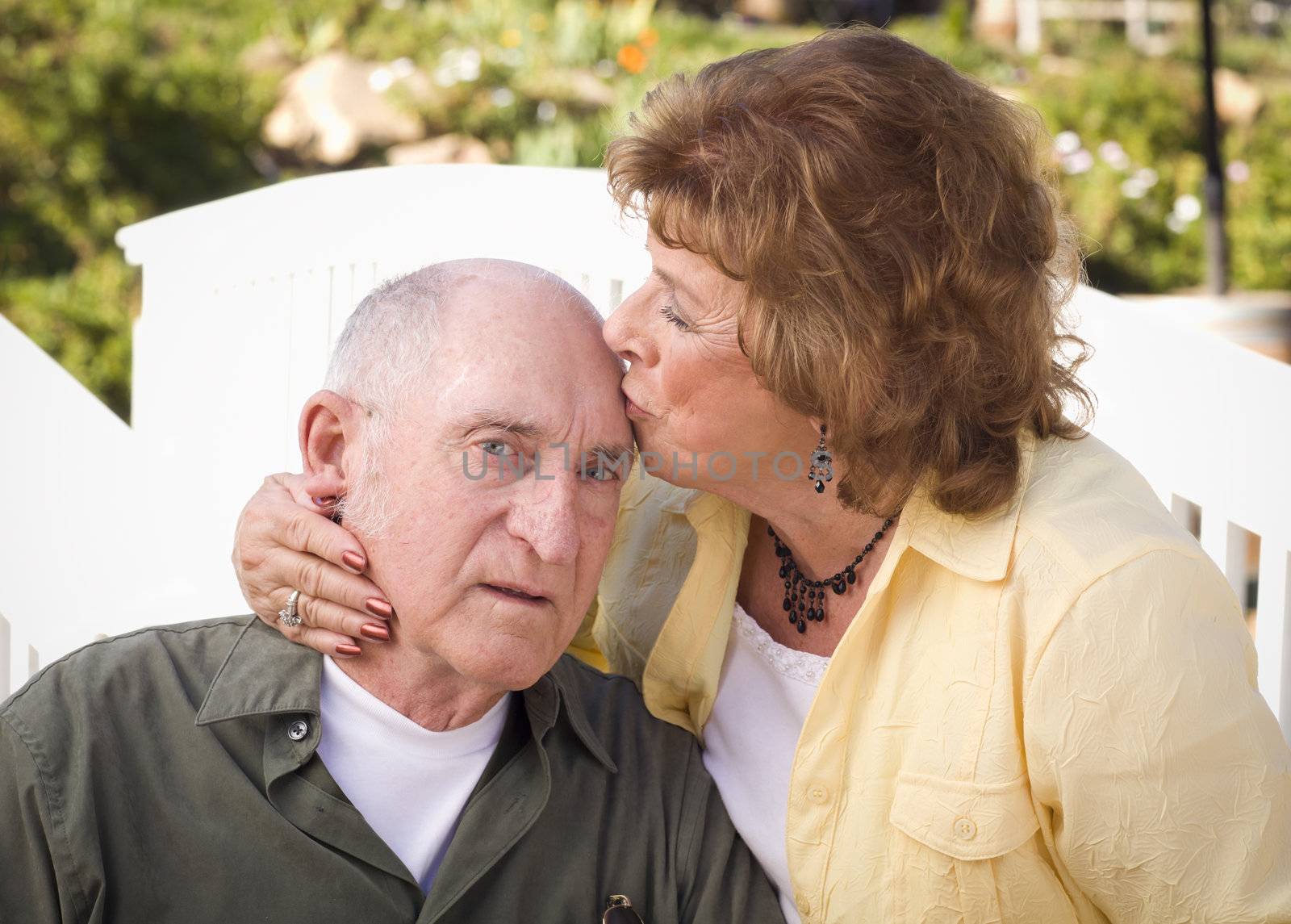 Happy Senior Couple Kissing in the Park.