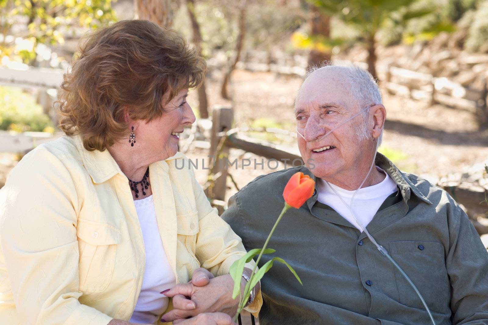 Senior Woman with Man Wearing Oxygen Tubes by Feverpitched