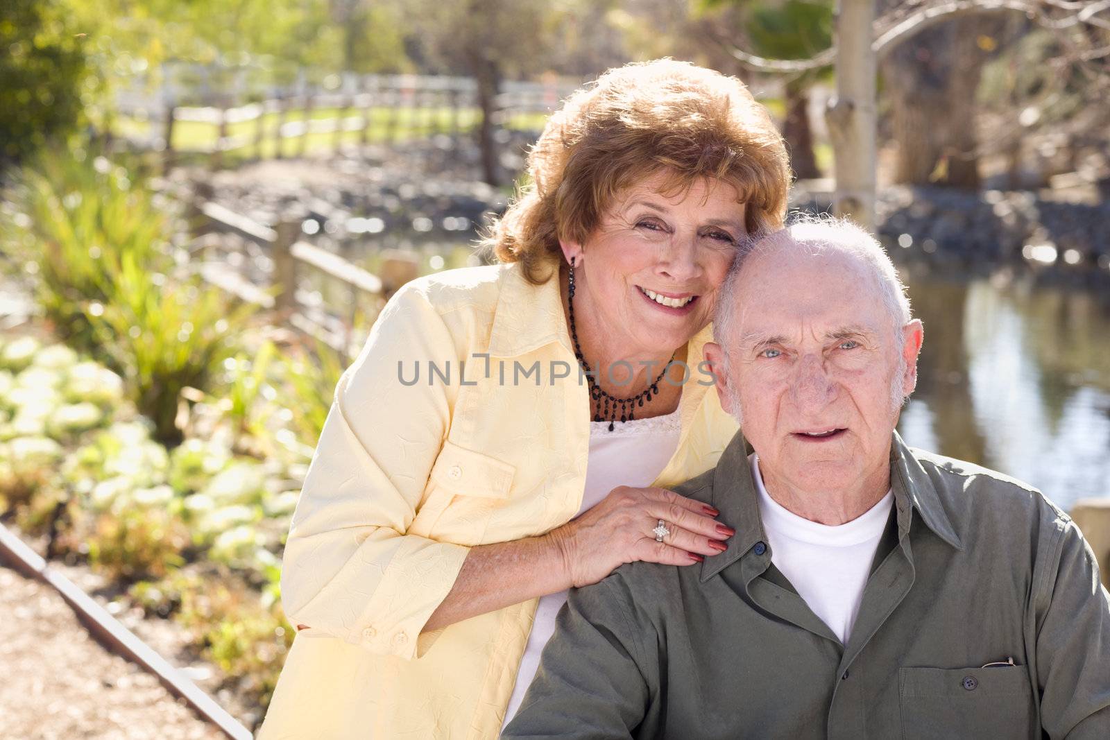 Happy Senior Couple Relaxing in The Park by Feverpitched