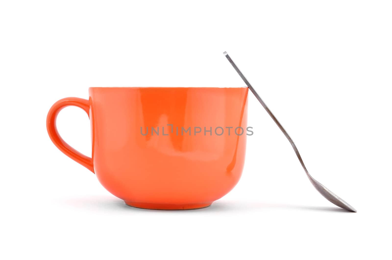 empty orange cup and spoon on a white background