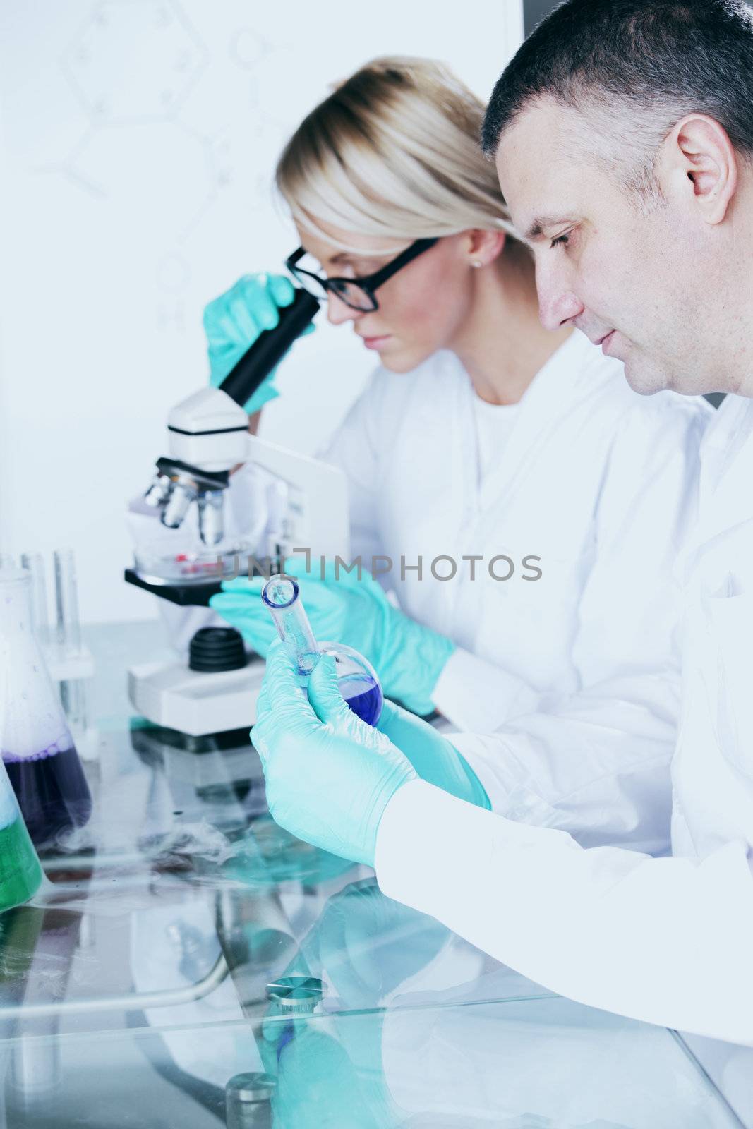  two scientist in chemical lab conducting experiments