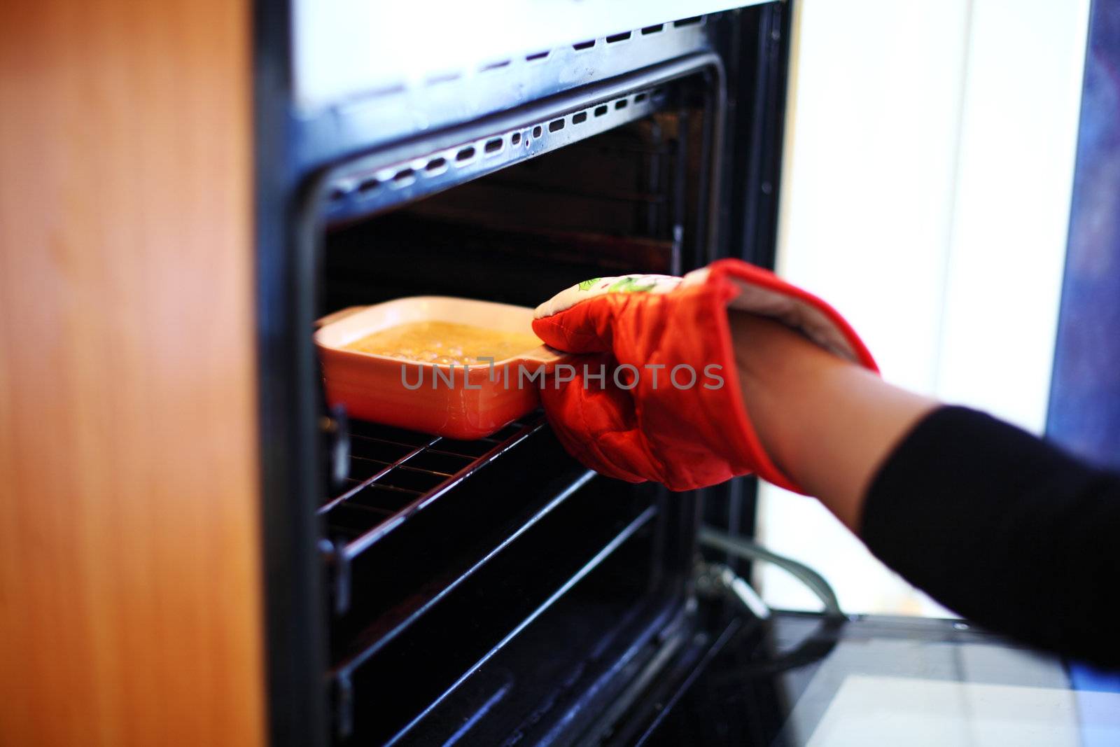 woman hand in gloves try to bake creme brulee