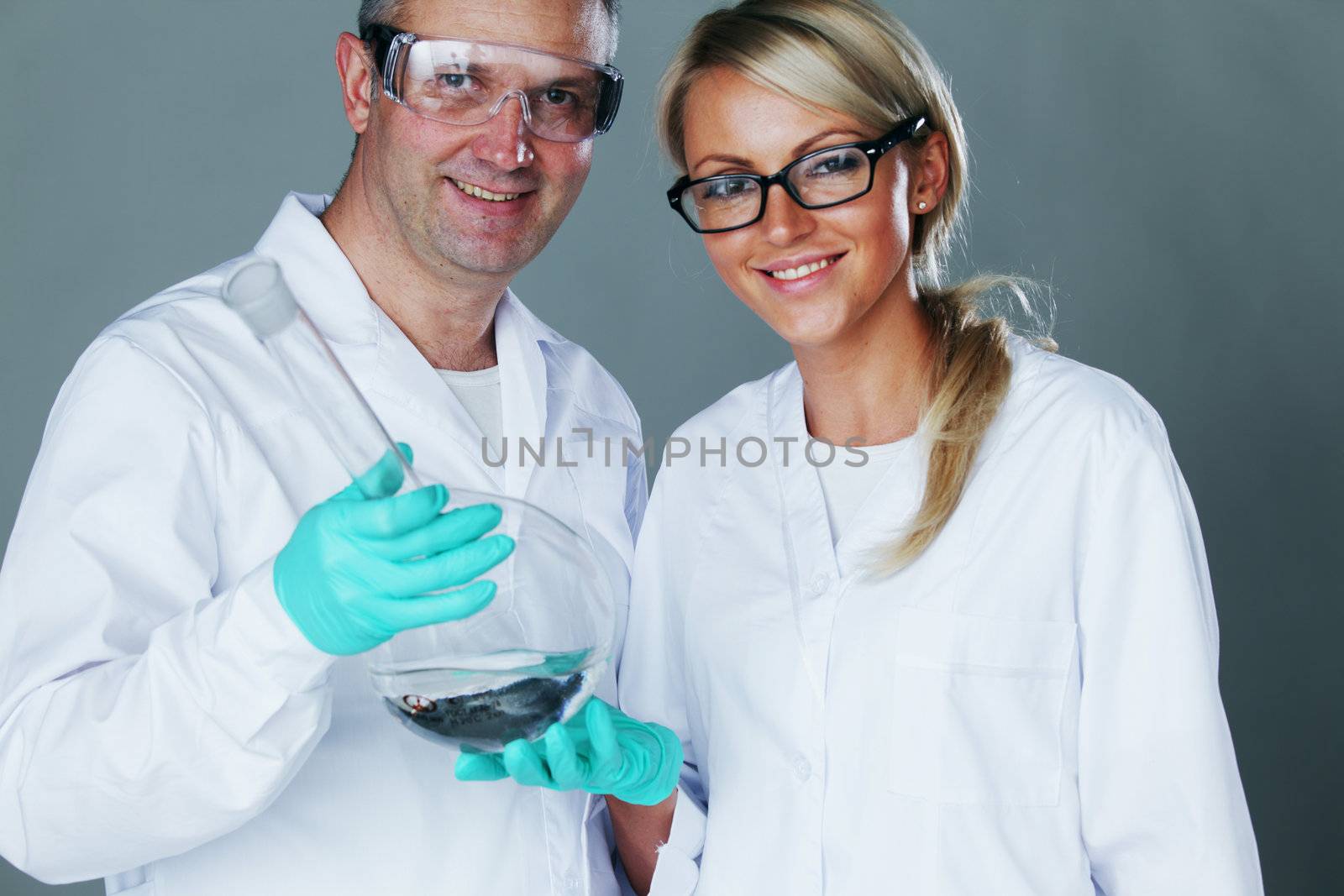  Chemistry researchers holding a secret green chemical substance