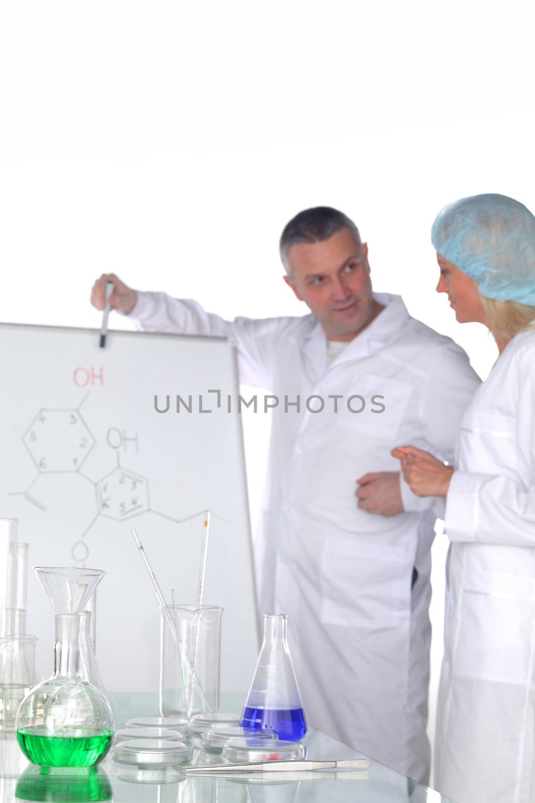  researchers holding a secret green chemical substance