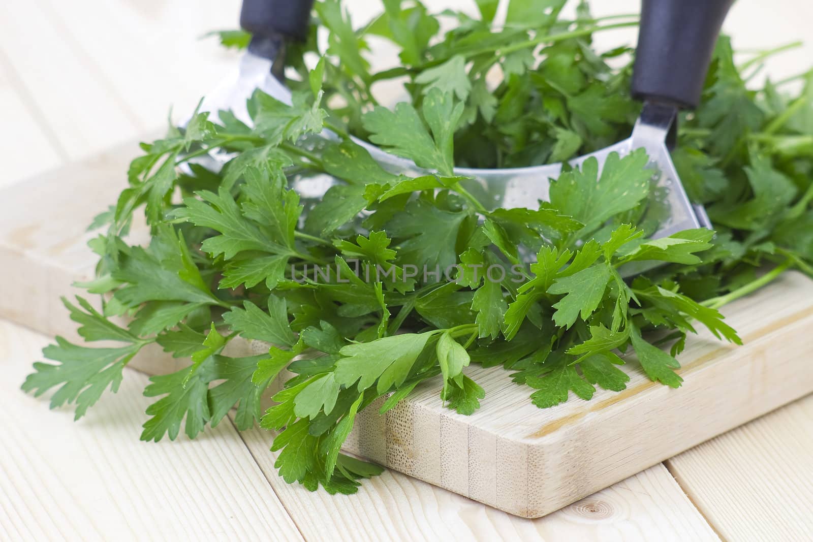Freshly chopped parsley on wooden cutting board