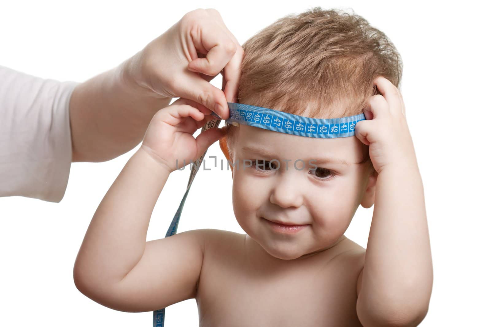 Measure tape in hand measuring child head isolated