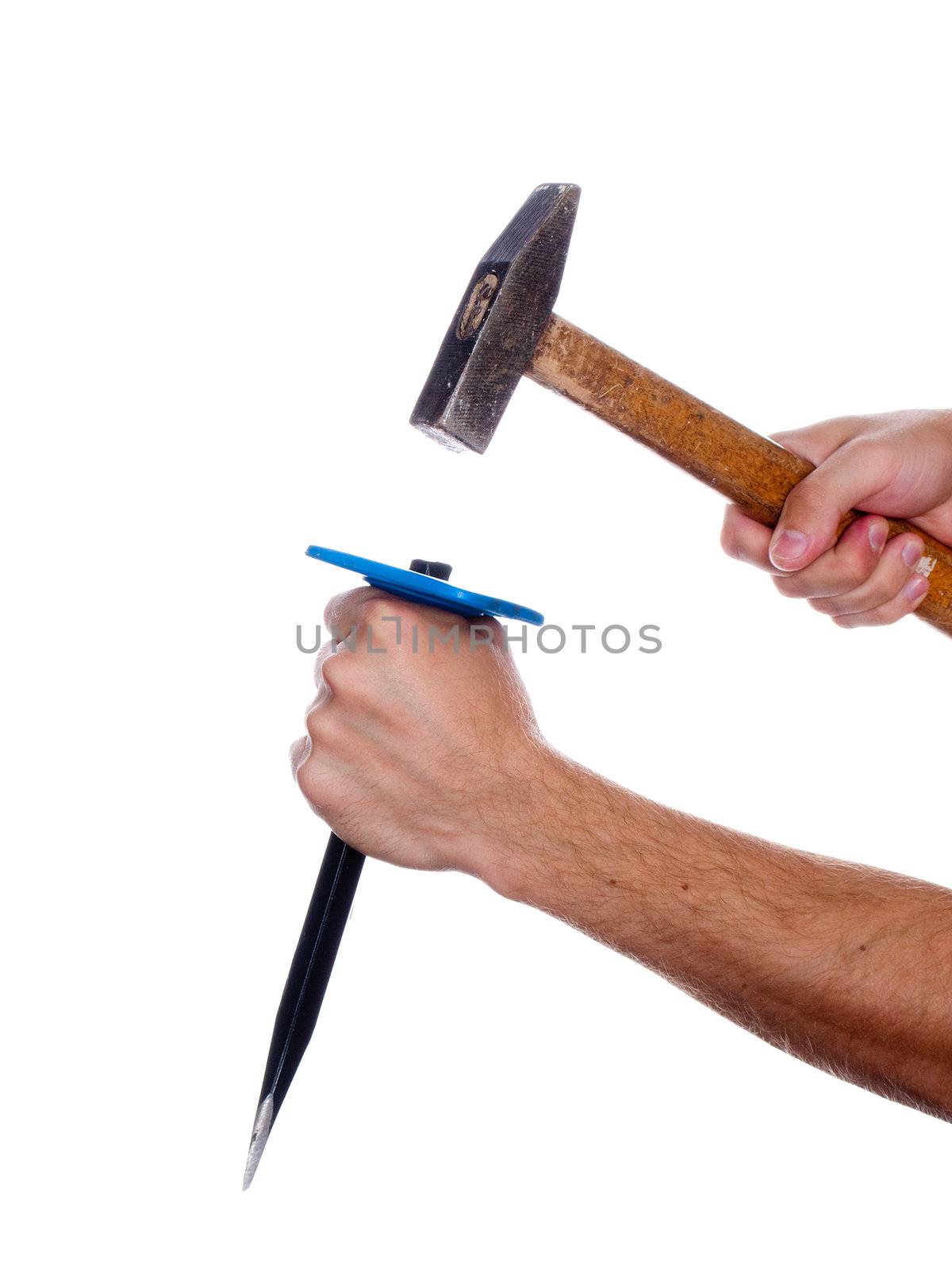 Human hand working with chisel tool and hammer