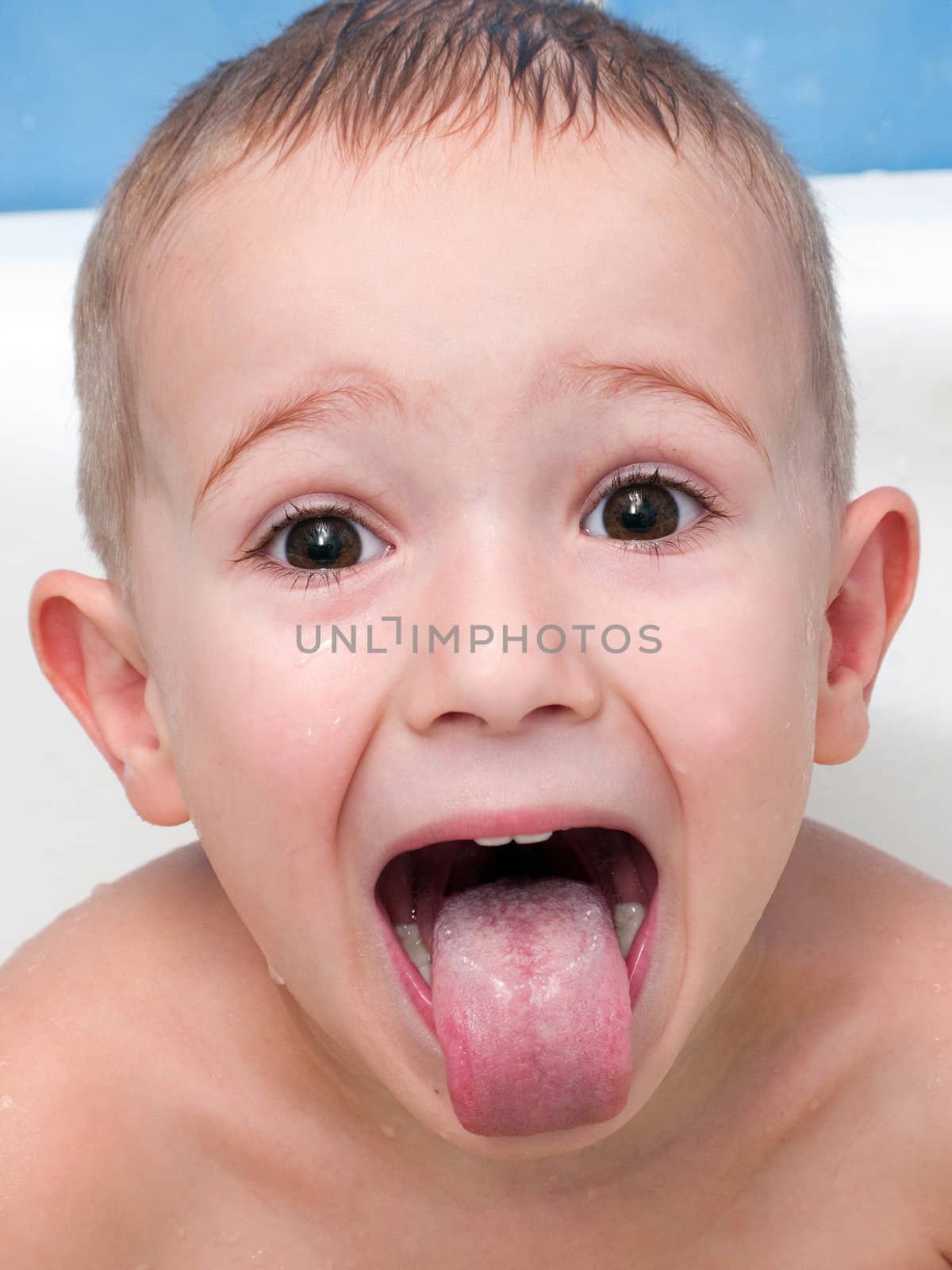 Little child making tongue for fun