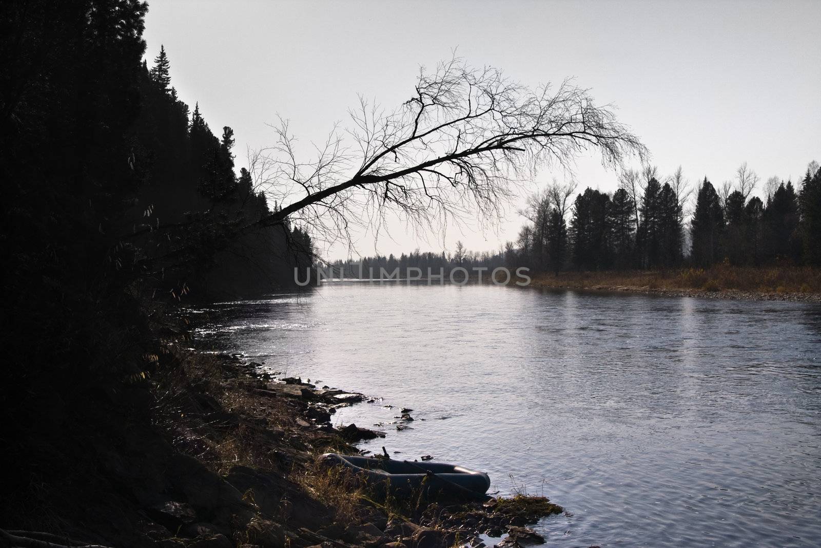 Inflatable boat on the river in autumn