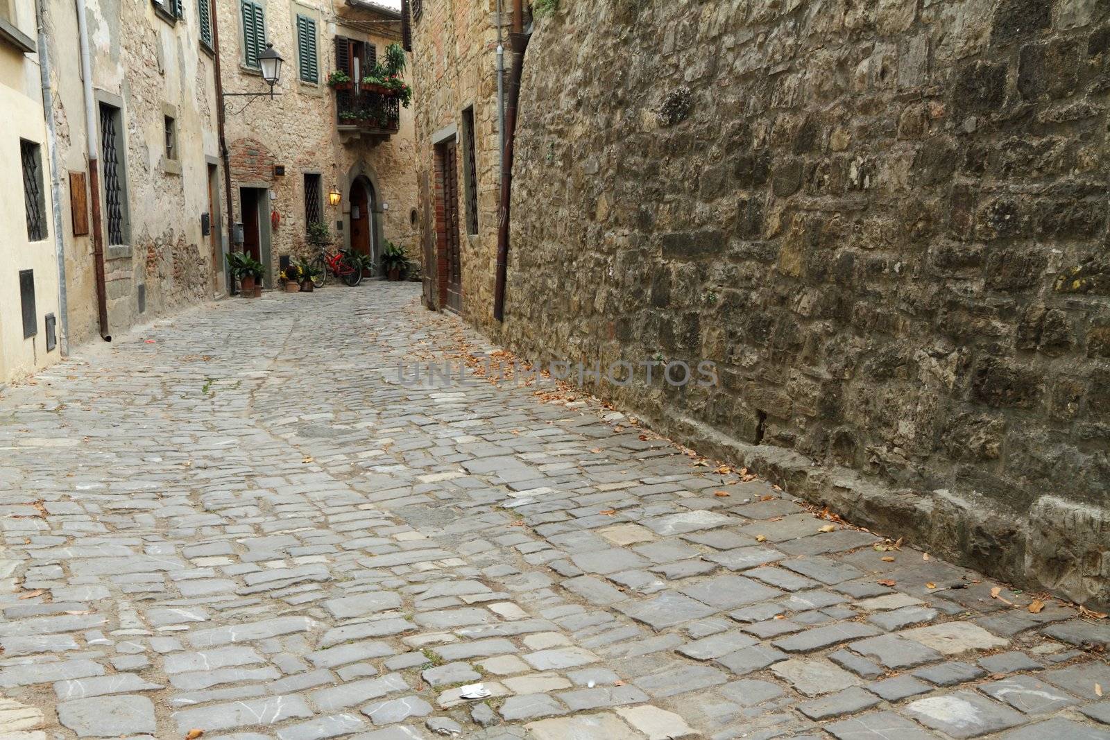 stony antique narrow street in tuscan village Montefioralle, Italy, Europe