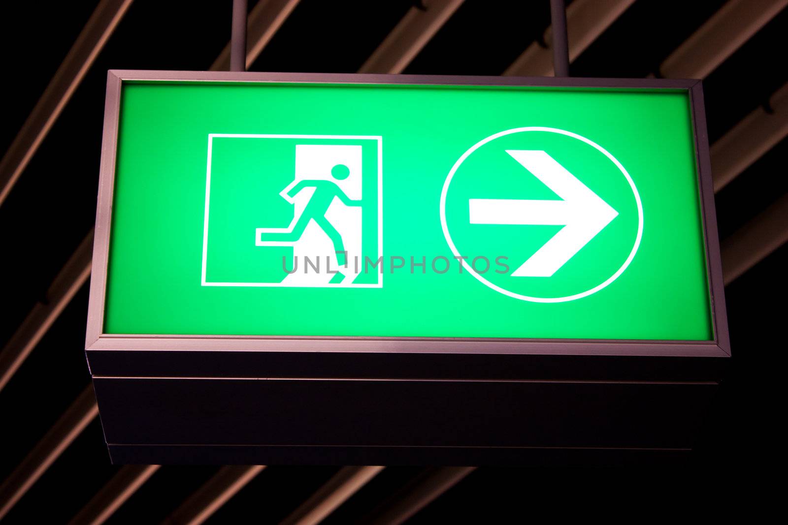 Emergency exit sign in modern offices inside an industrial plant