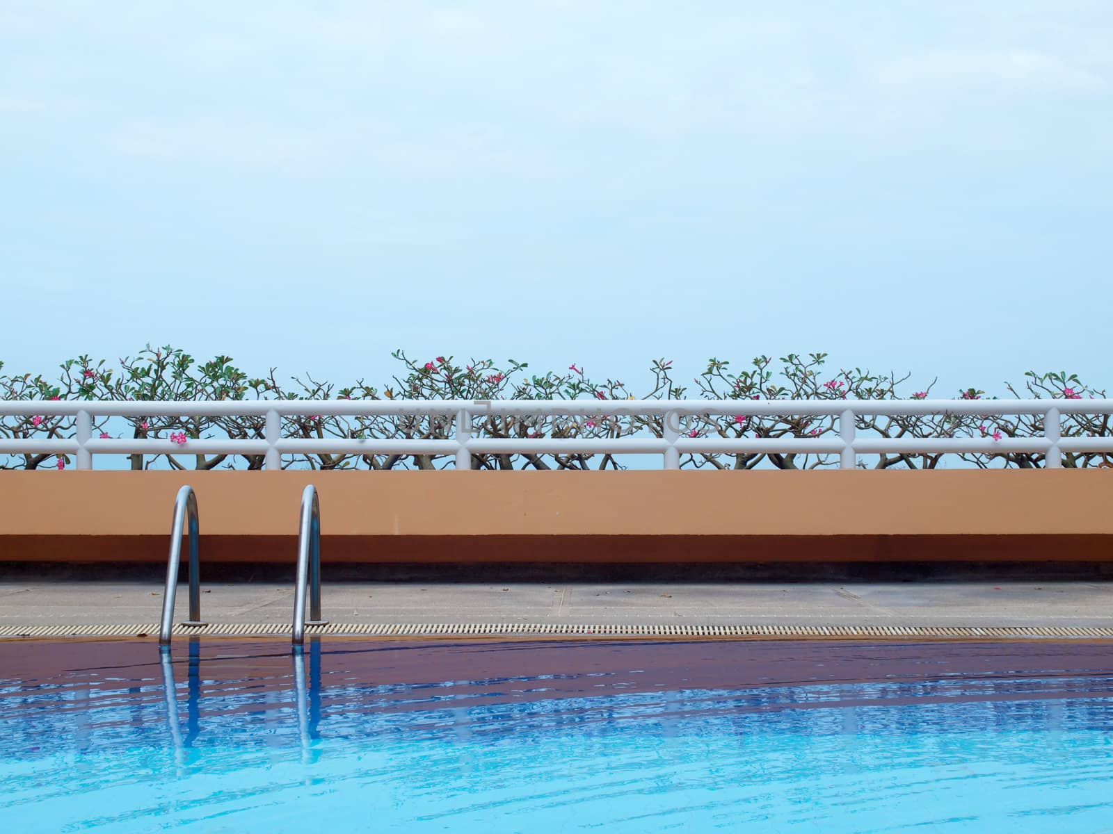 Swimming pool with blue water on terrace of condominium