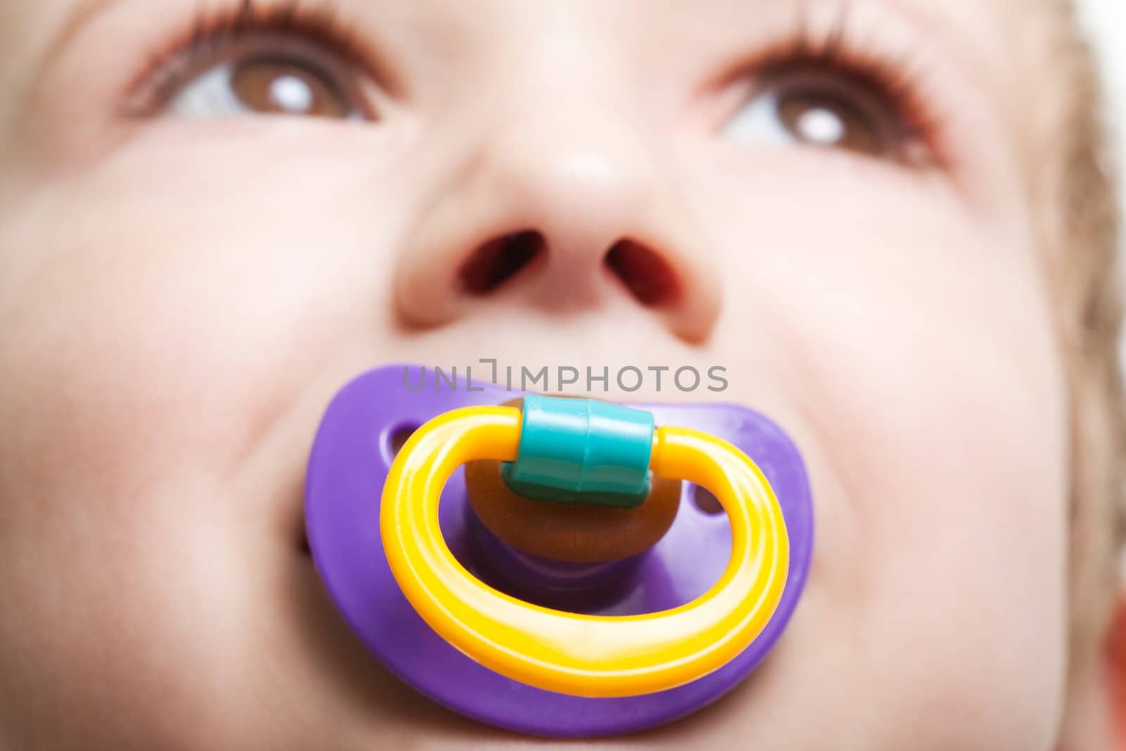 Little child boy and plastic baby soother pacifier