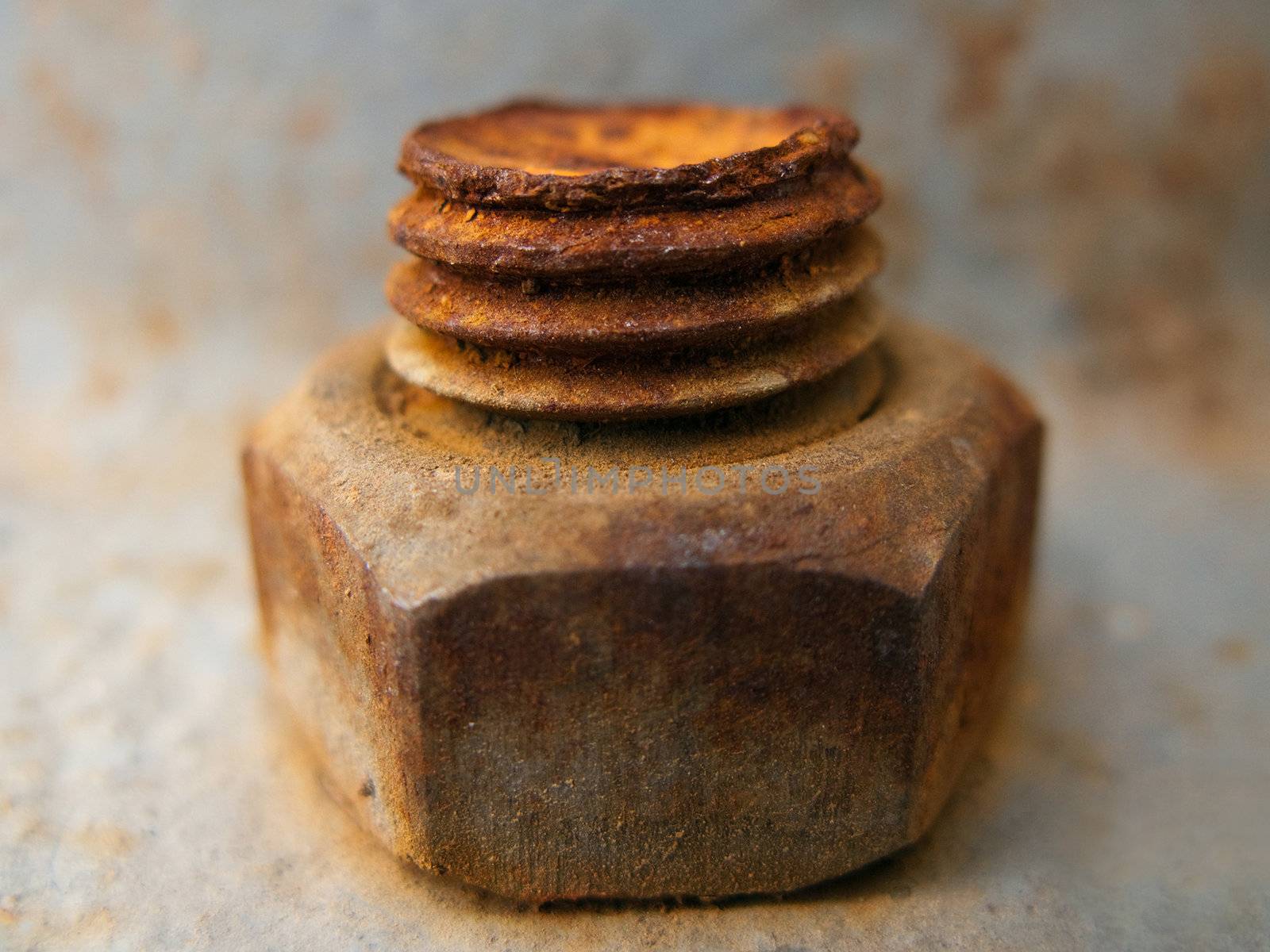 Old rusty metal nut on iron water valve pipe