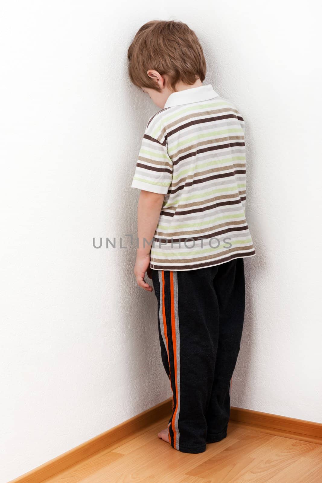 Little child boy wall corner punishment standing