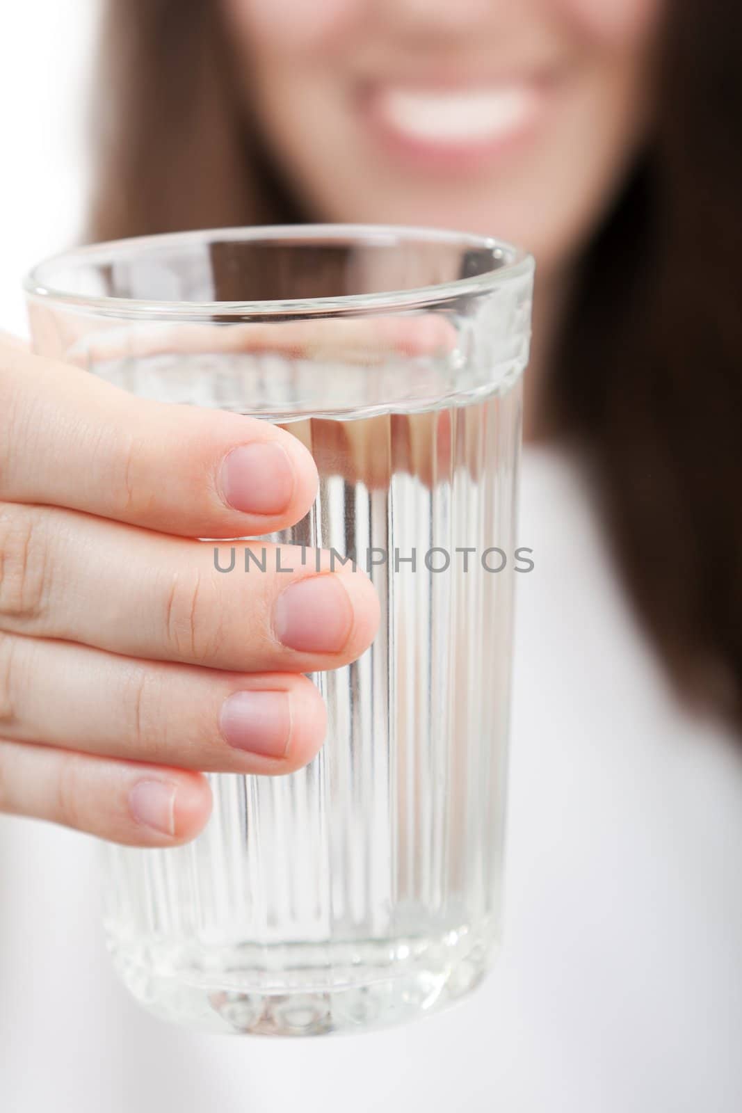 Female human hand holding liquid drink water glass