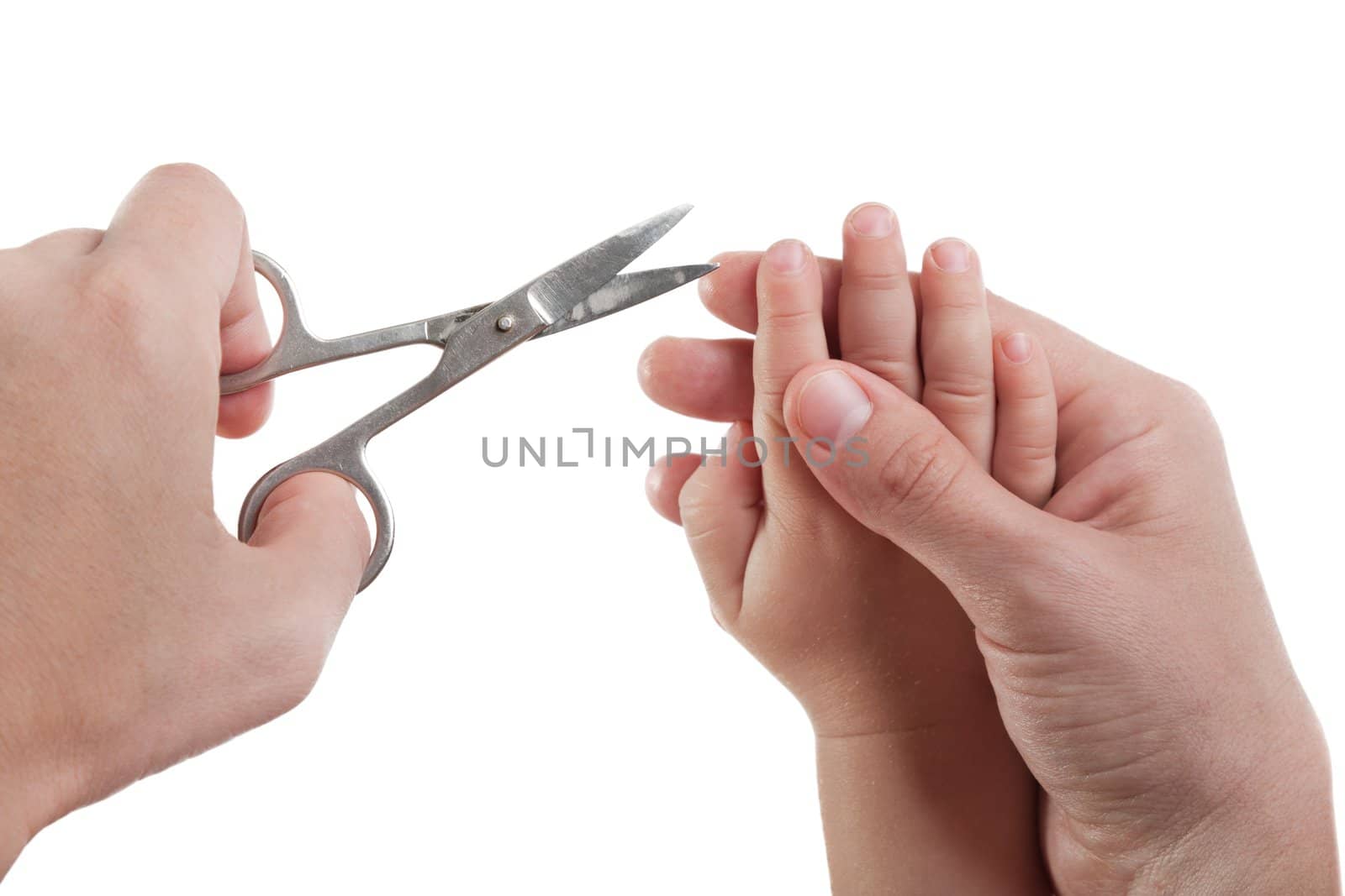 Human hand holding scissors trim child fingernail