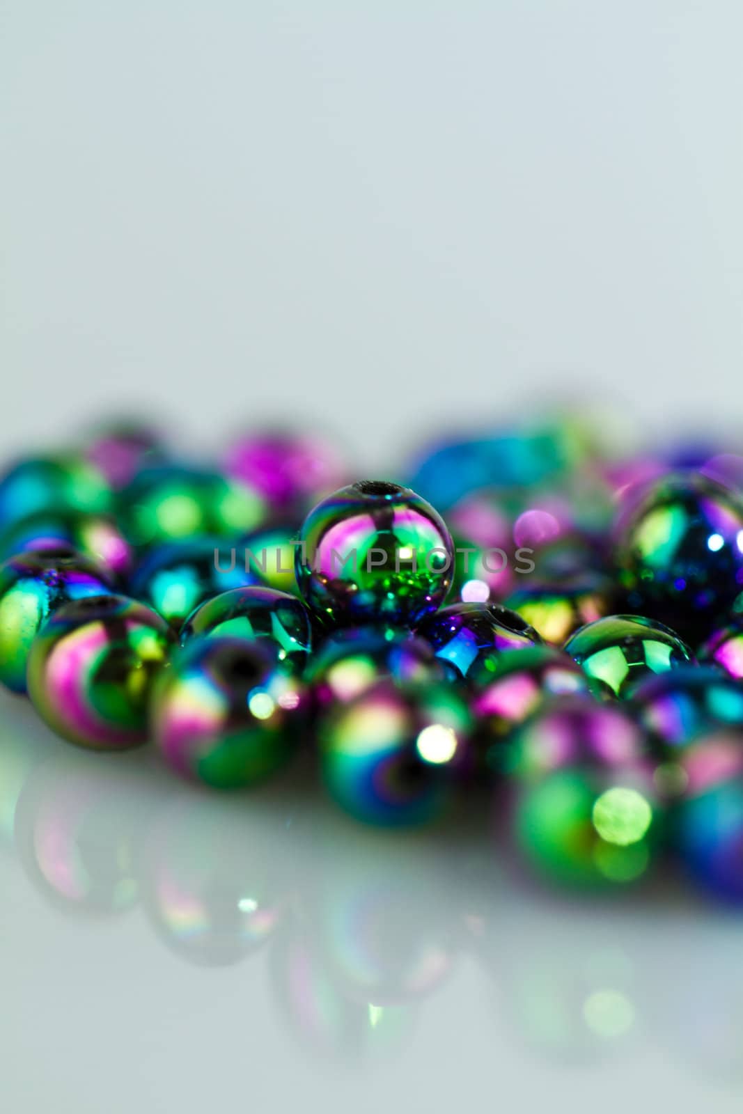 Blue beads on bluish background from right in portrait orientation