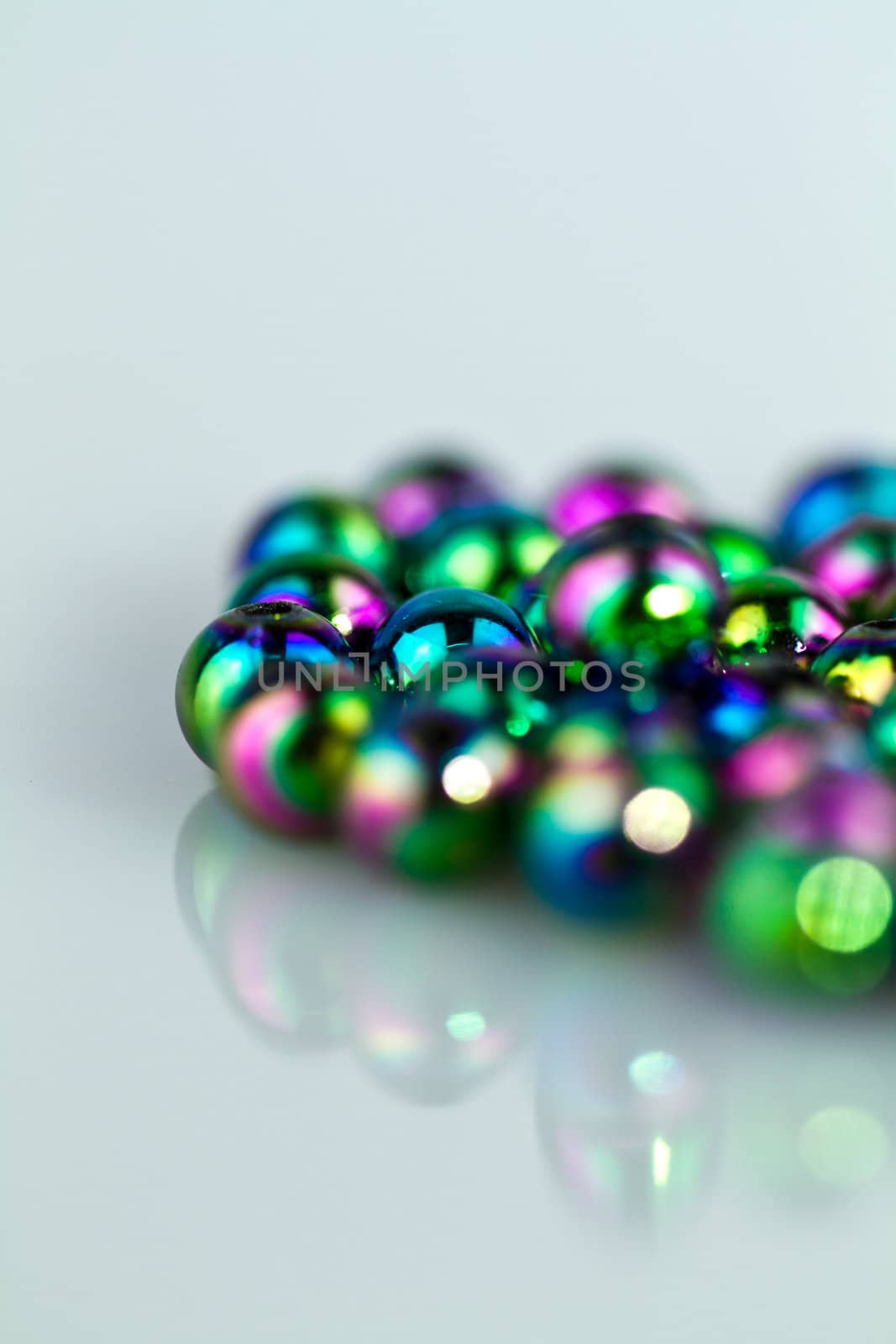 Blue beads on bluish background from right in portrait orientation