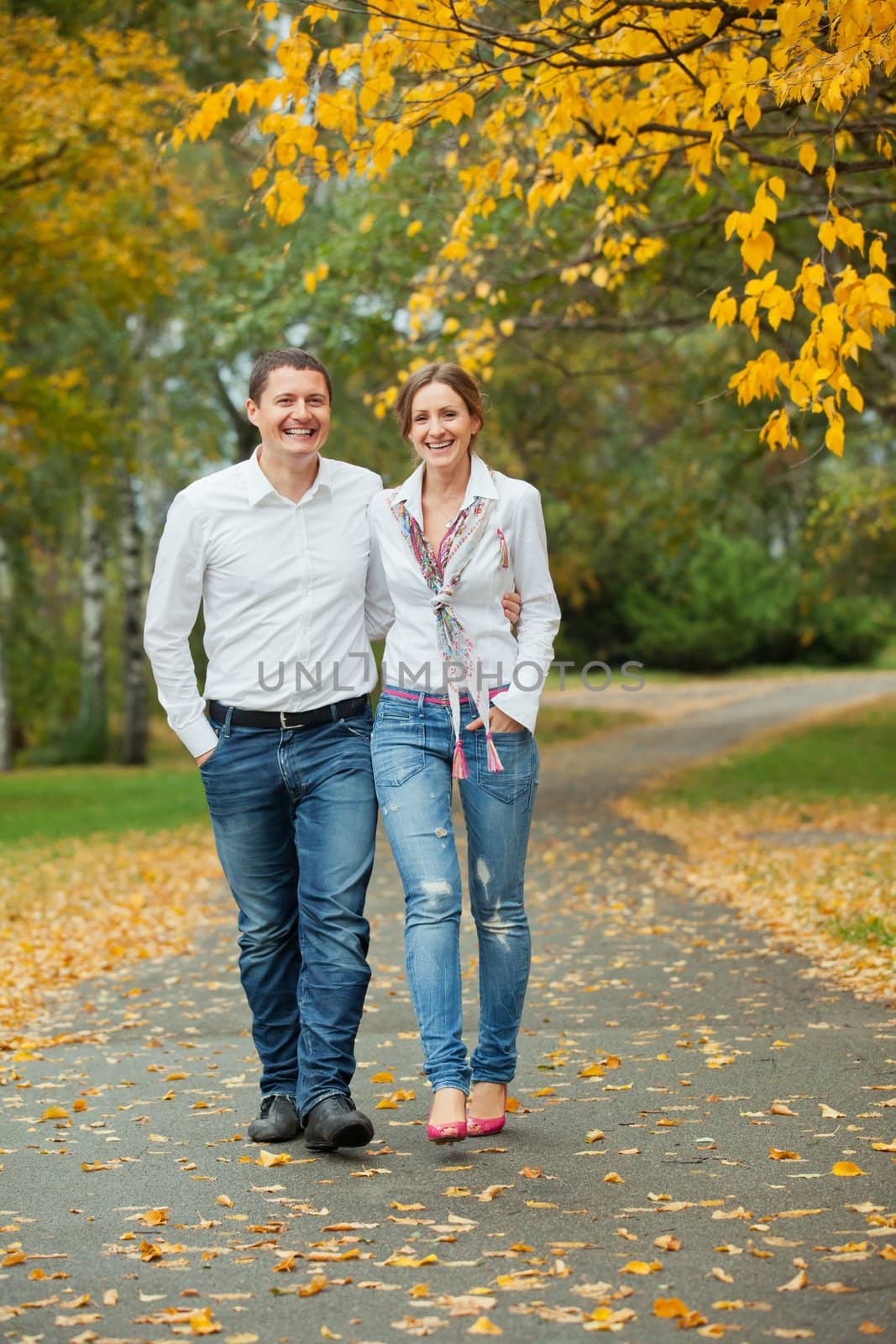 Romantic happy young beautiful couple on autumn walk. Vertical view