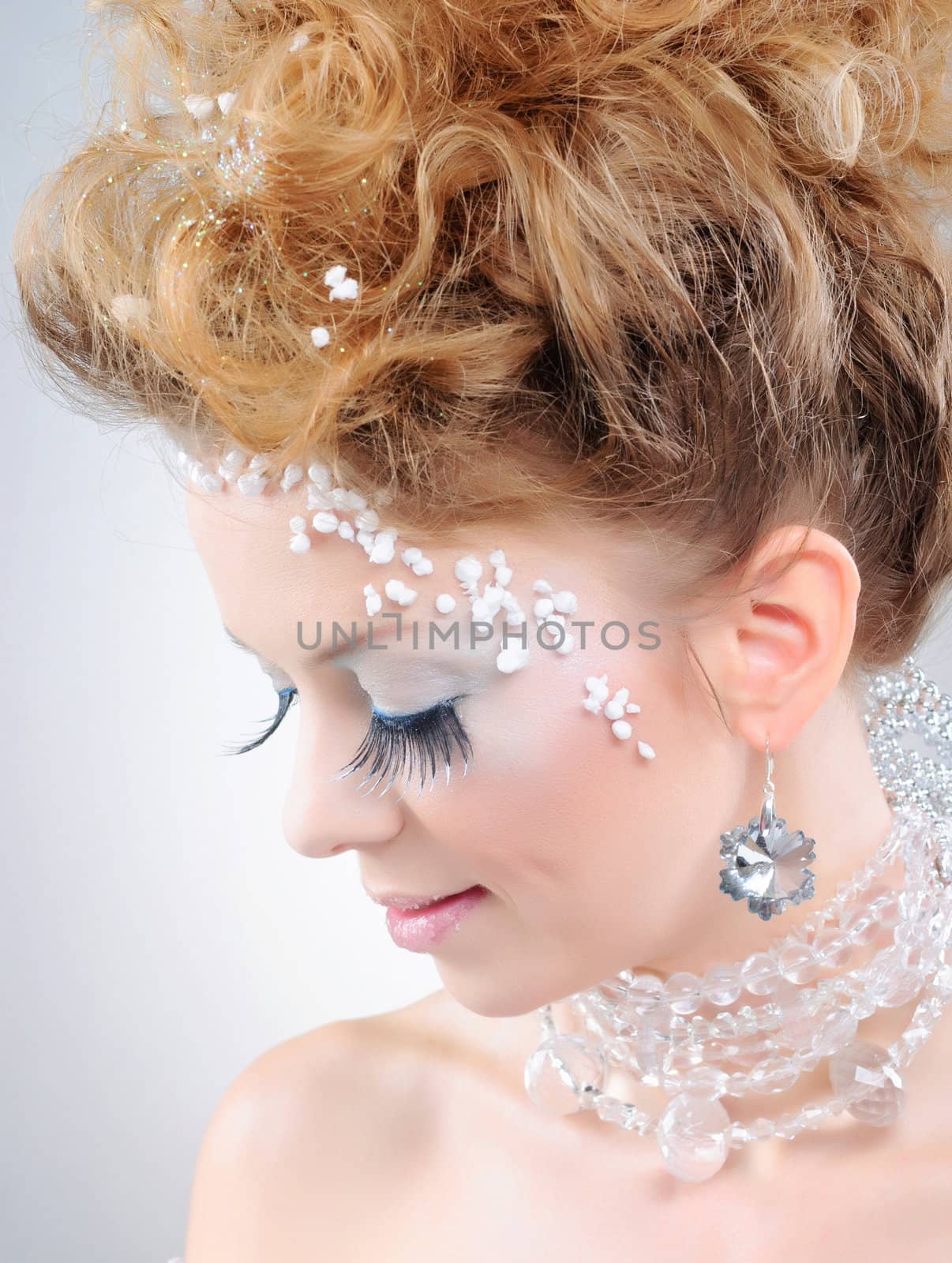 Closeup portrait of young beautiful girl with fantasy winter make-up