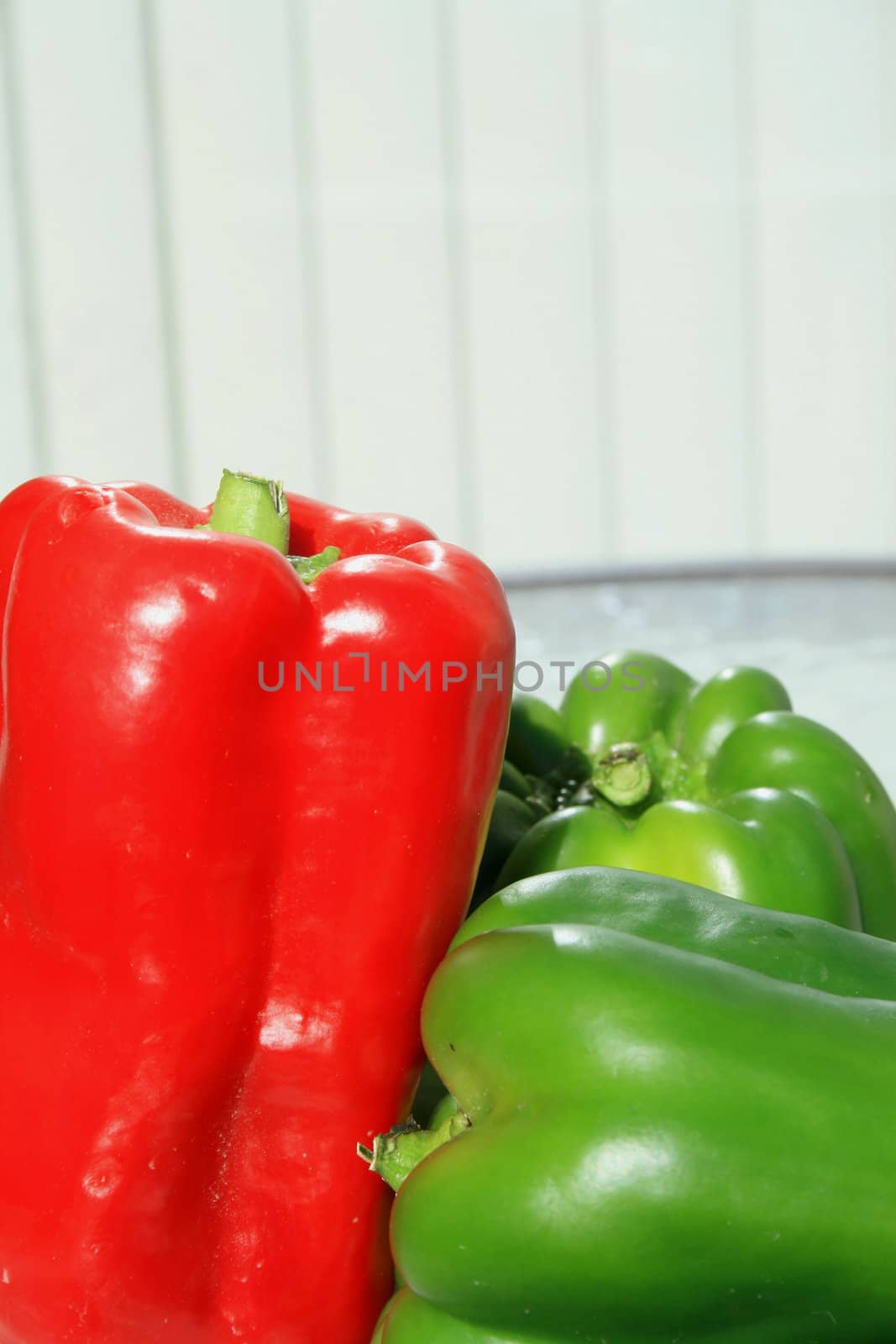 Close up of the red and green bell peppers on a plate.