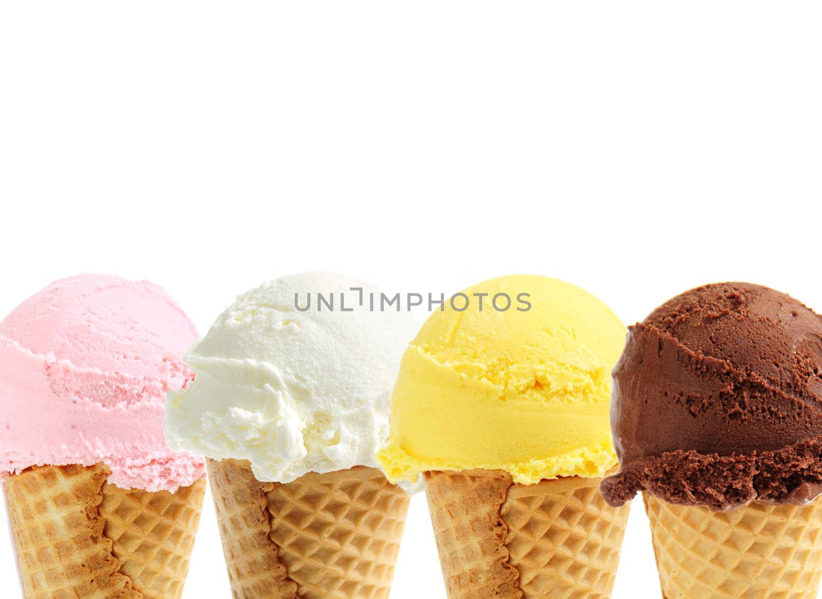 Assorted ice cream in sugar cones on white background