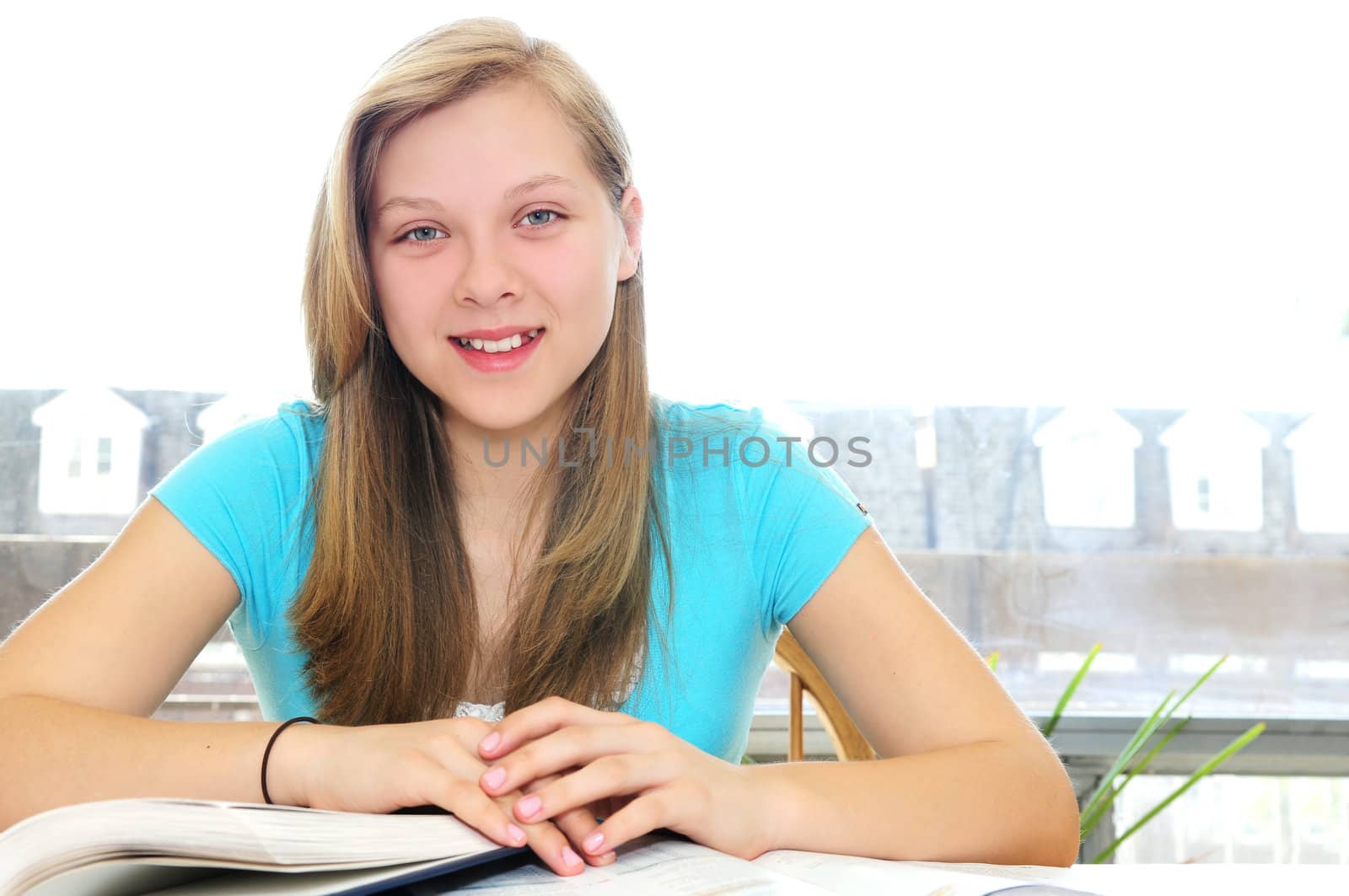 Happy teenage girl studying by elenathewise