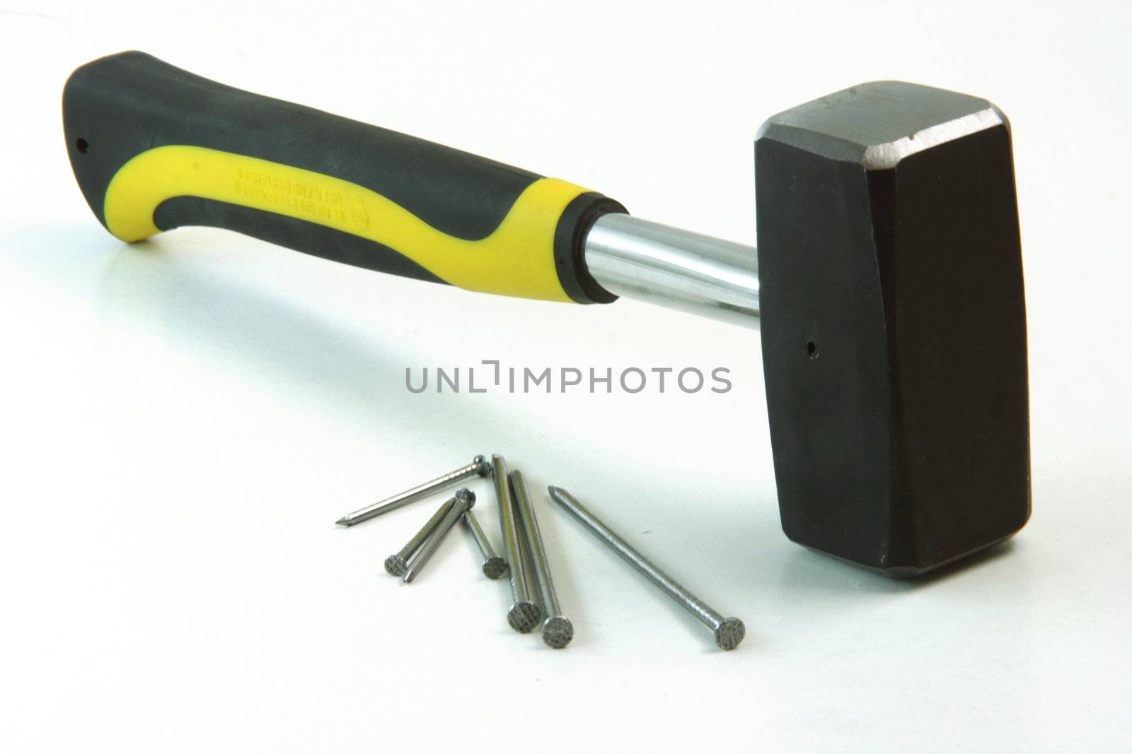 contruction concepts hammer with contruction nails in white background