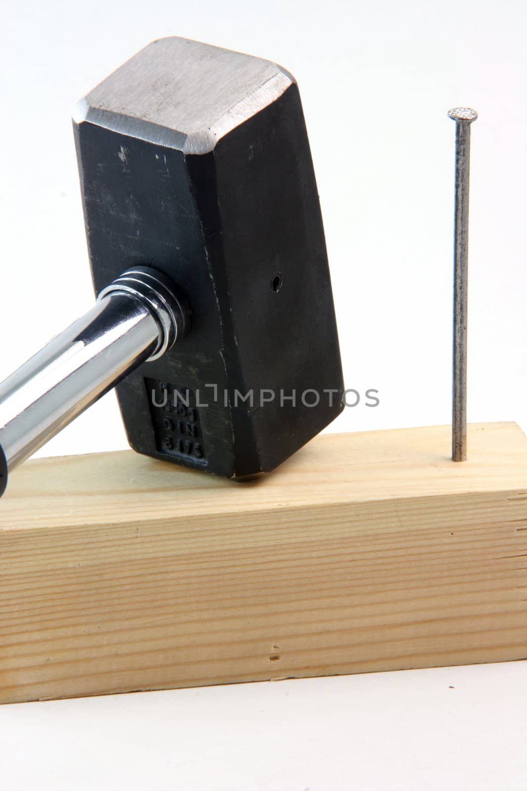 contruction concepts hammer with wood and nail stuck detail in white background