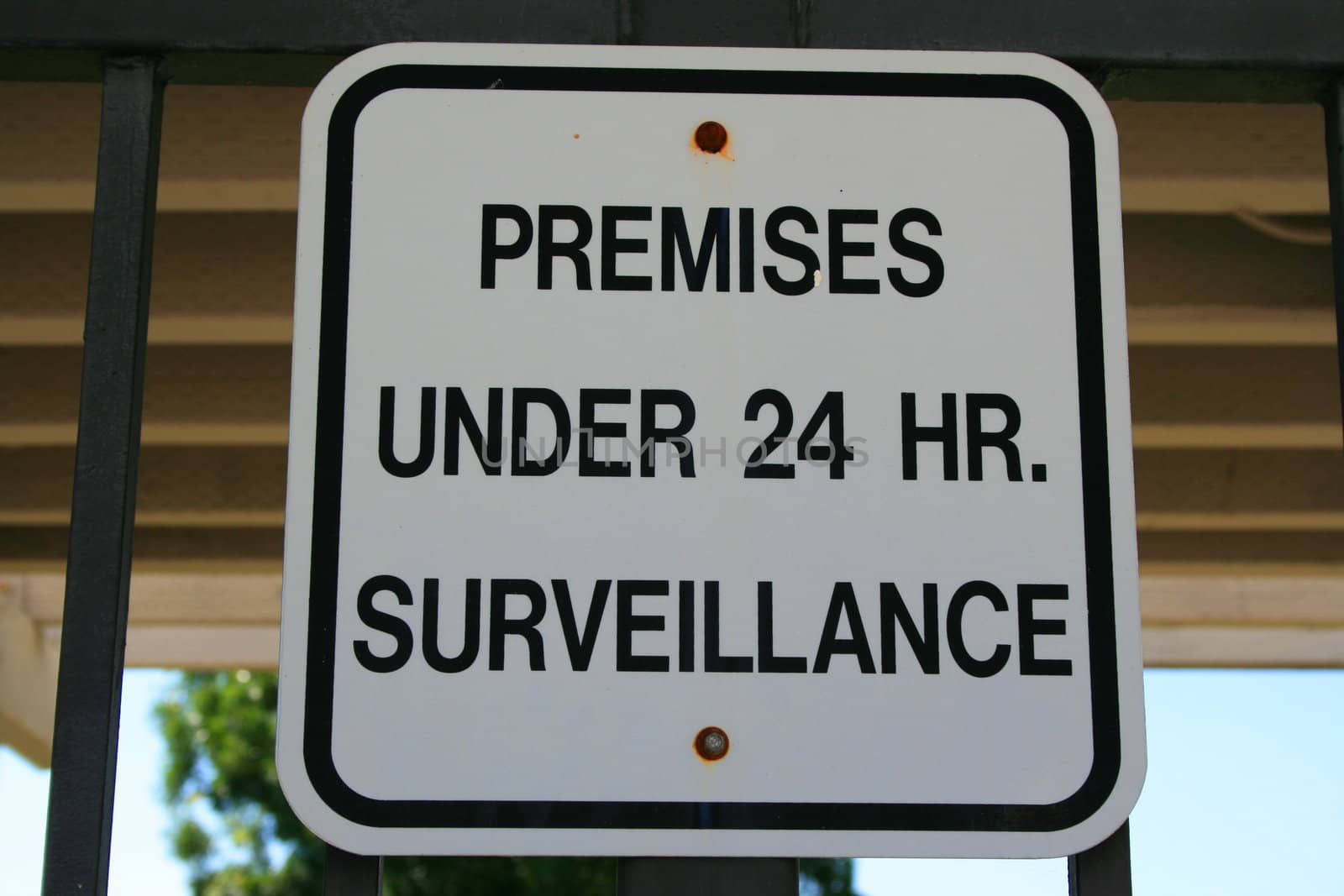 Premises under 24 hour surveillance warning sign.
